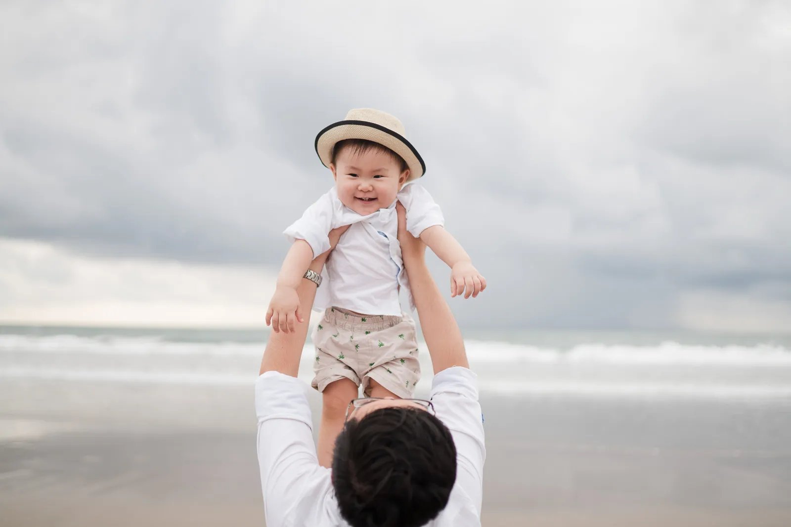 Baby portrait during multigeneration family session at Alila Seminyak Bali with soft natural beach light.