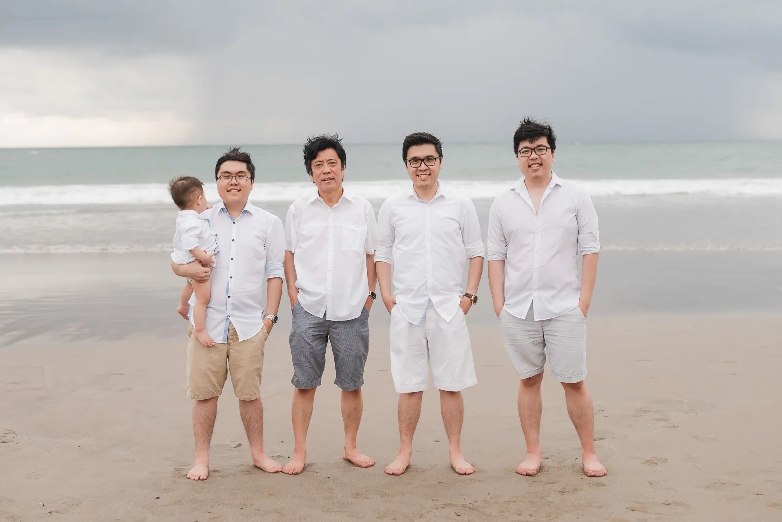 Multigeneration family portrait at Seminyak Beach Bali during relaxed natural family photography session.