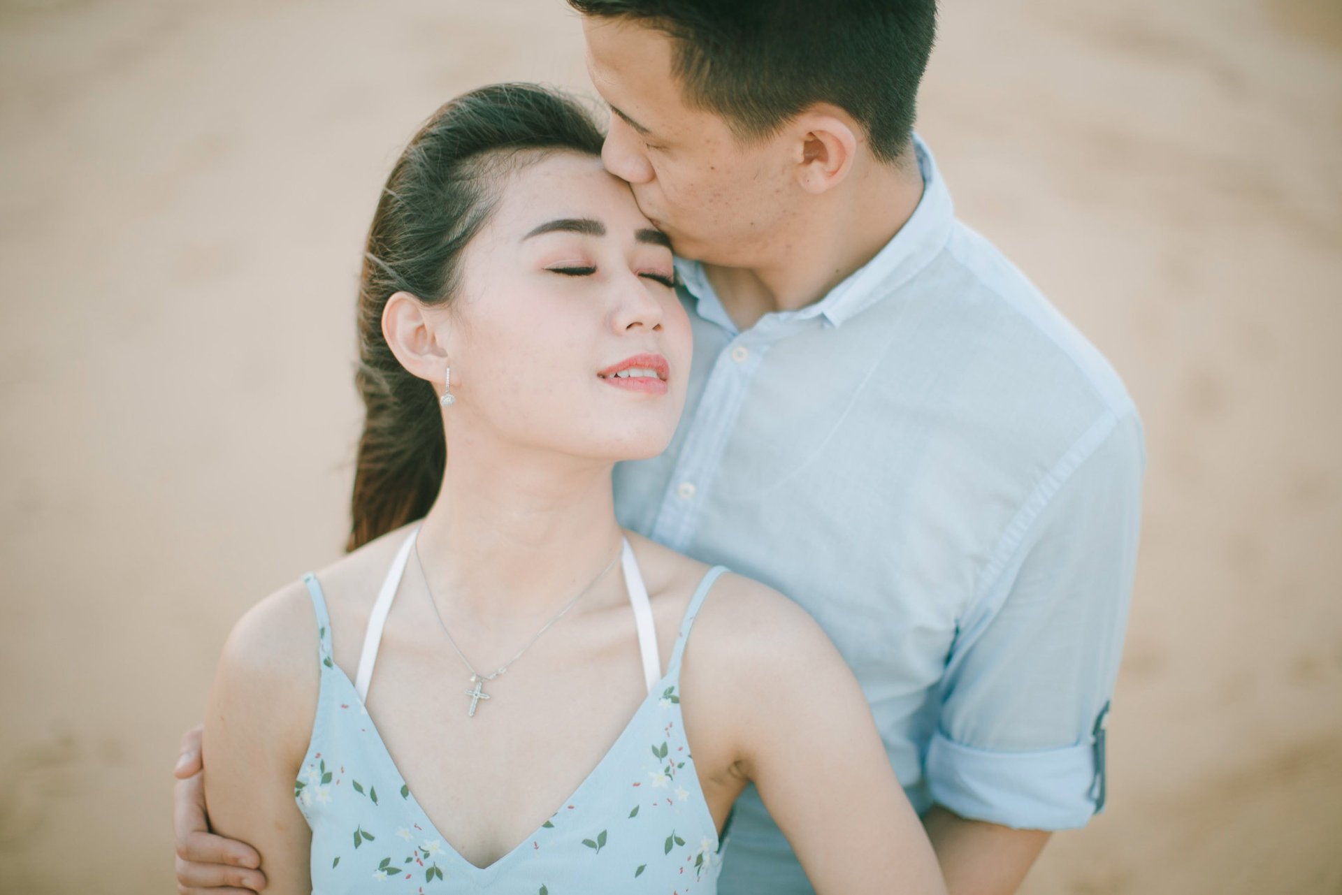Close intimate couple portrait on beach at Sofitel Bali Nusa Dua Beach Resort.