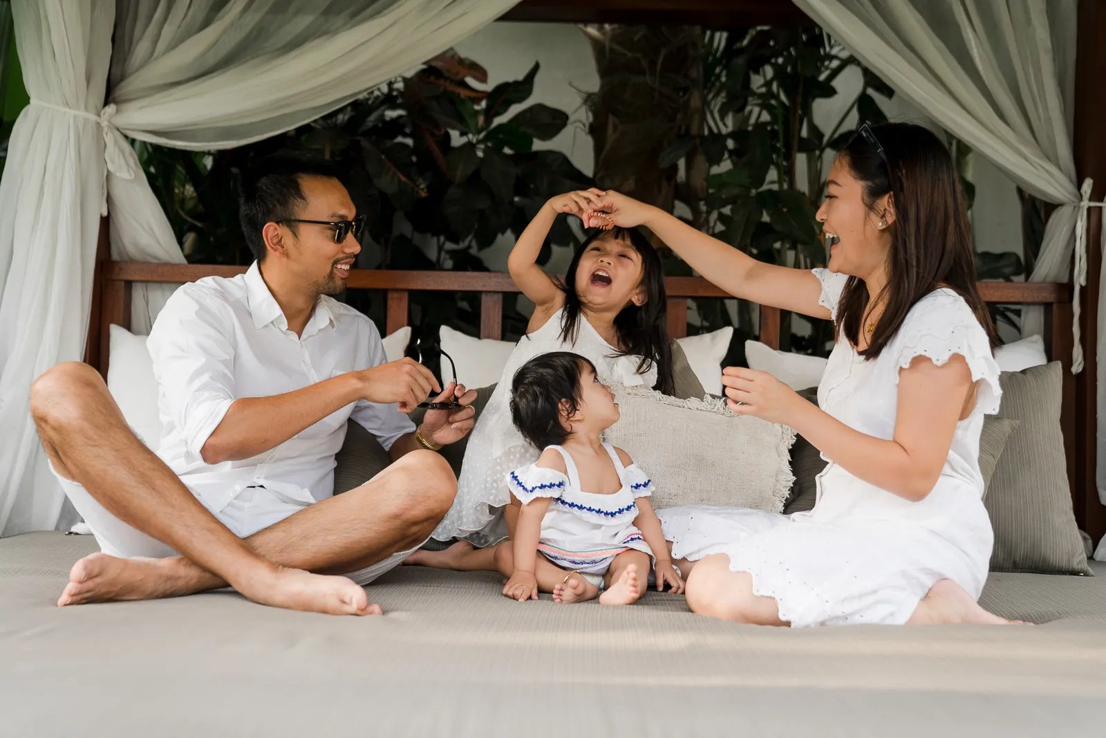 Natural family moments inside a private villa in Seminyak Bali with parents and children relaxing together during a photograp