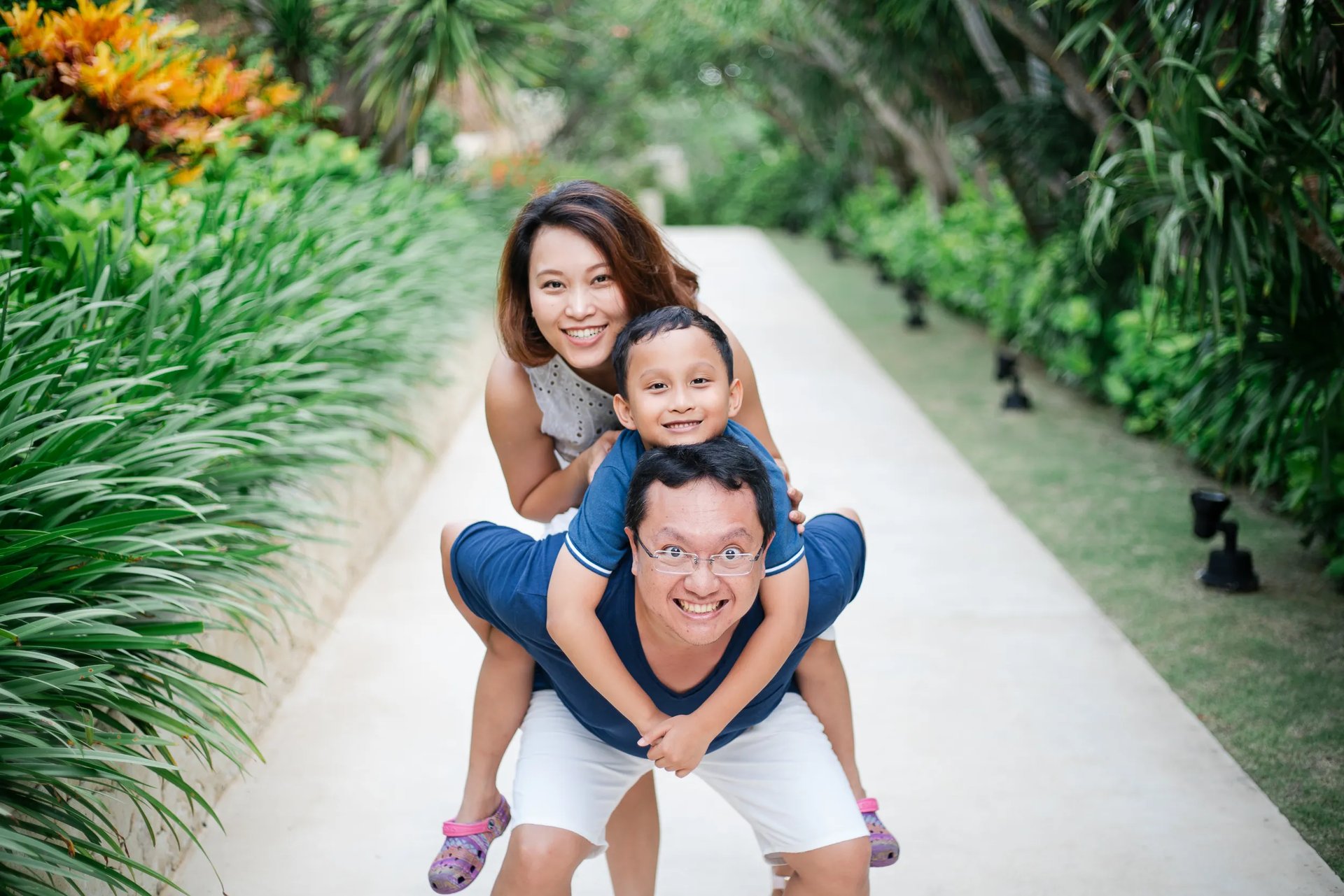 Happy family portrait on resort walkway at The Mulia Nusa Dua Bali