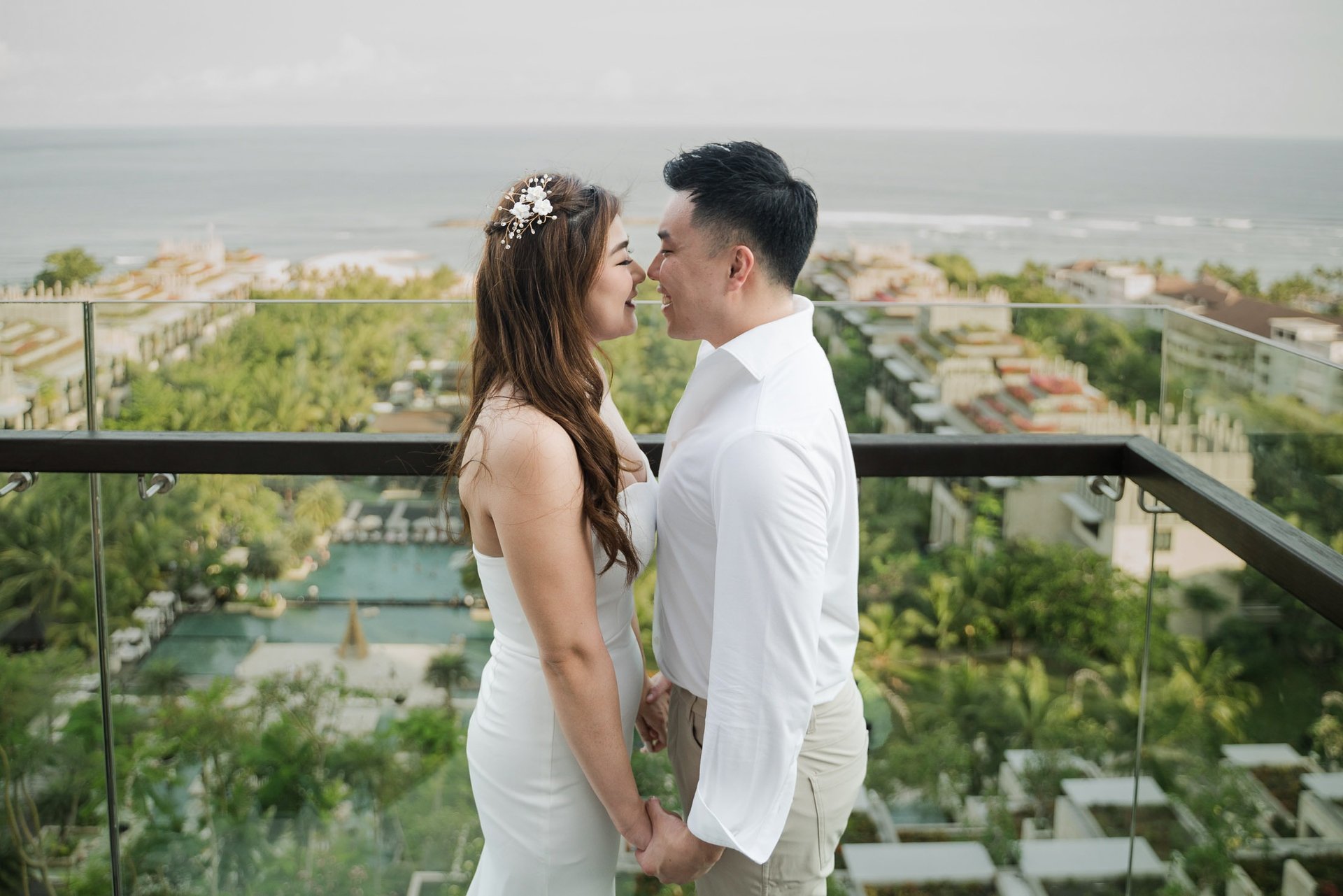 Romantic couple portrait overlooking the ocean during a prewedding photoshoot at Apurva Kempinski Bali