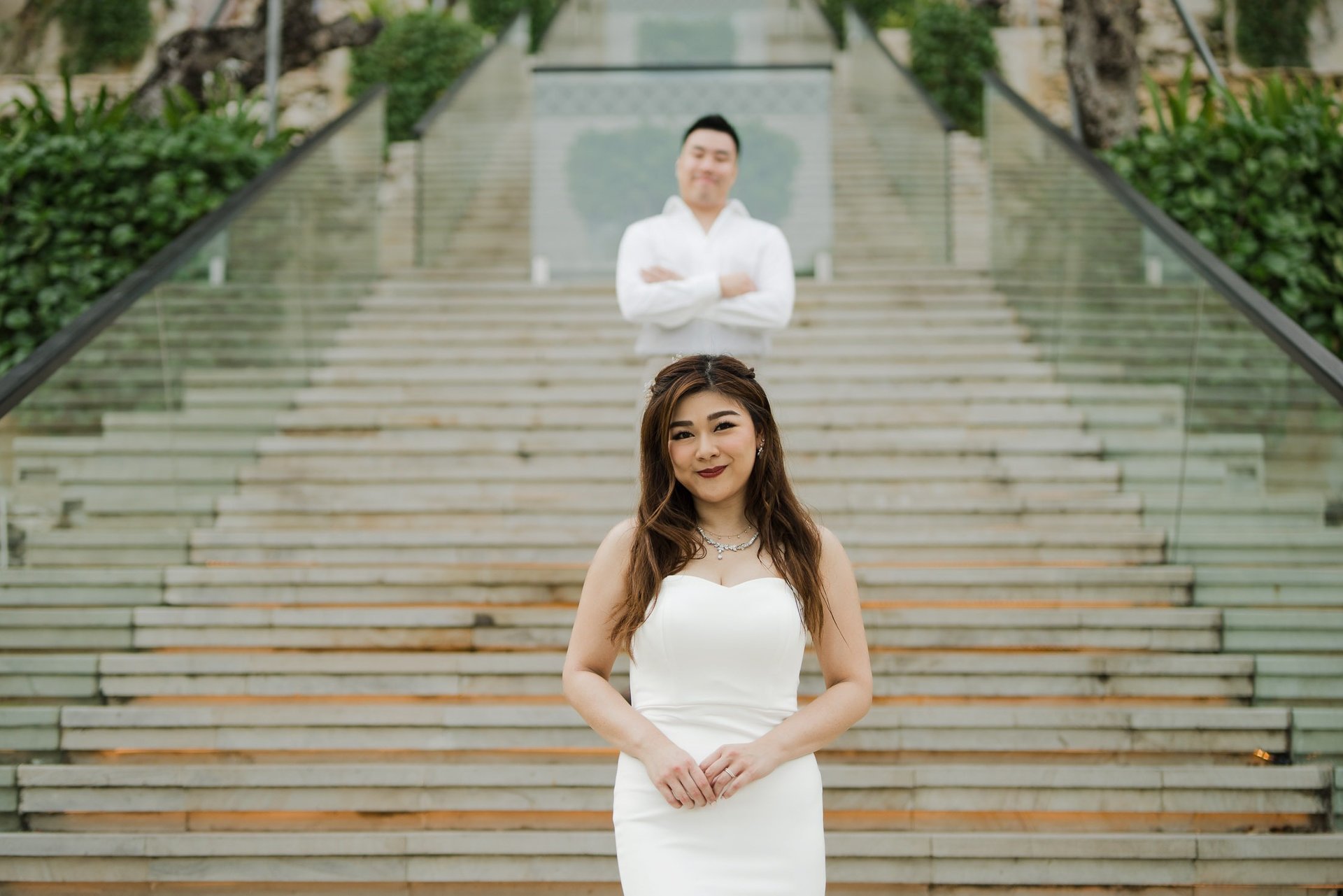 Elegant portrait of a couple on the grand staircase during a prewedding photoshoot at Apurva Kempinski Bali