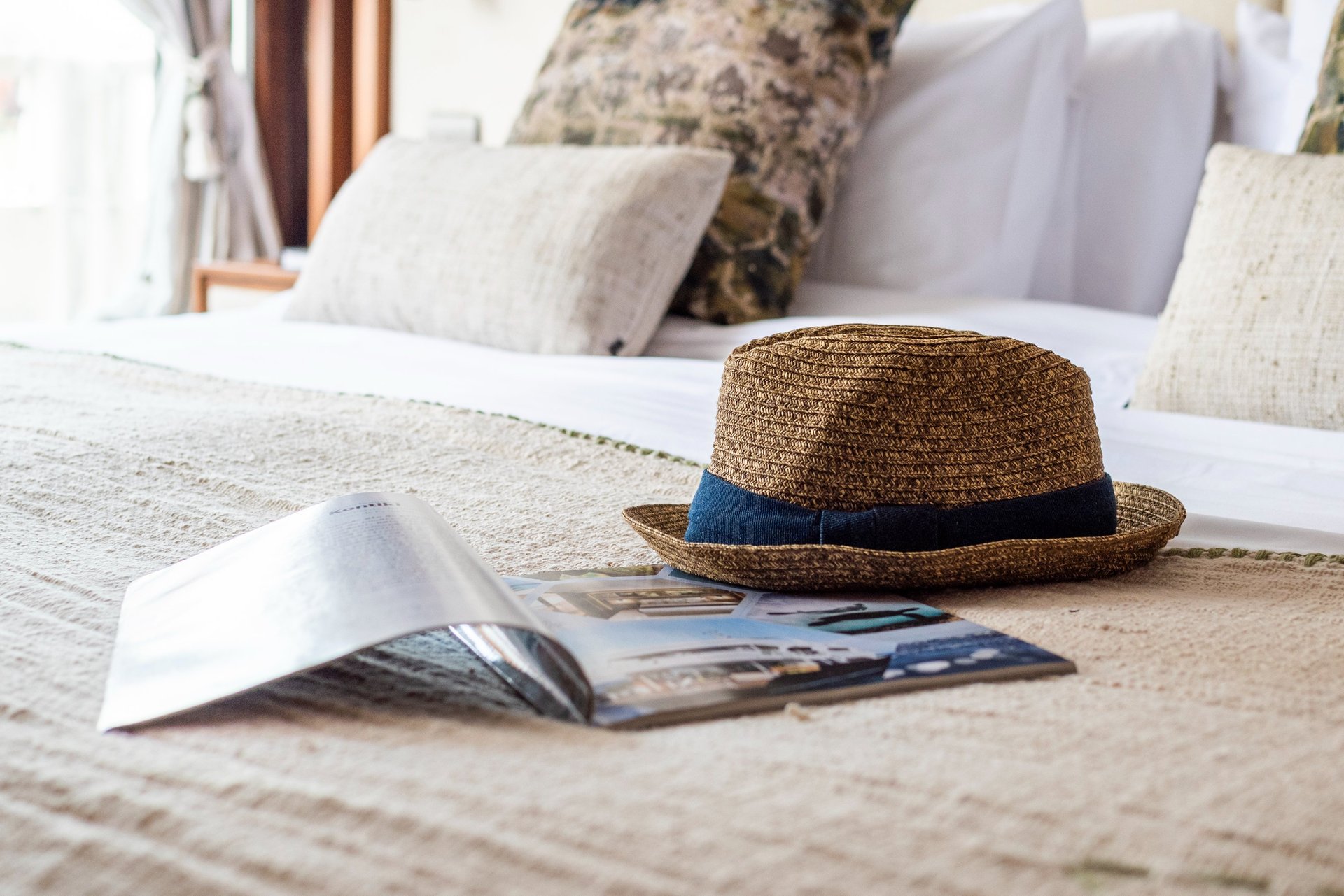 Curated luxury travel lifestyle detail with natural textures, evoking slow travel