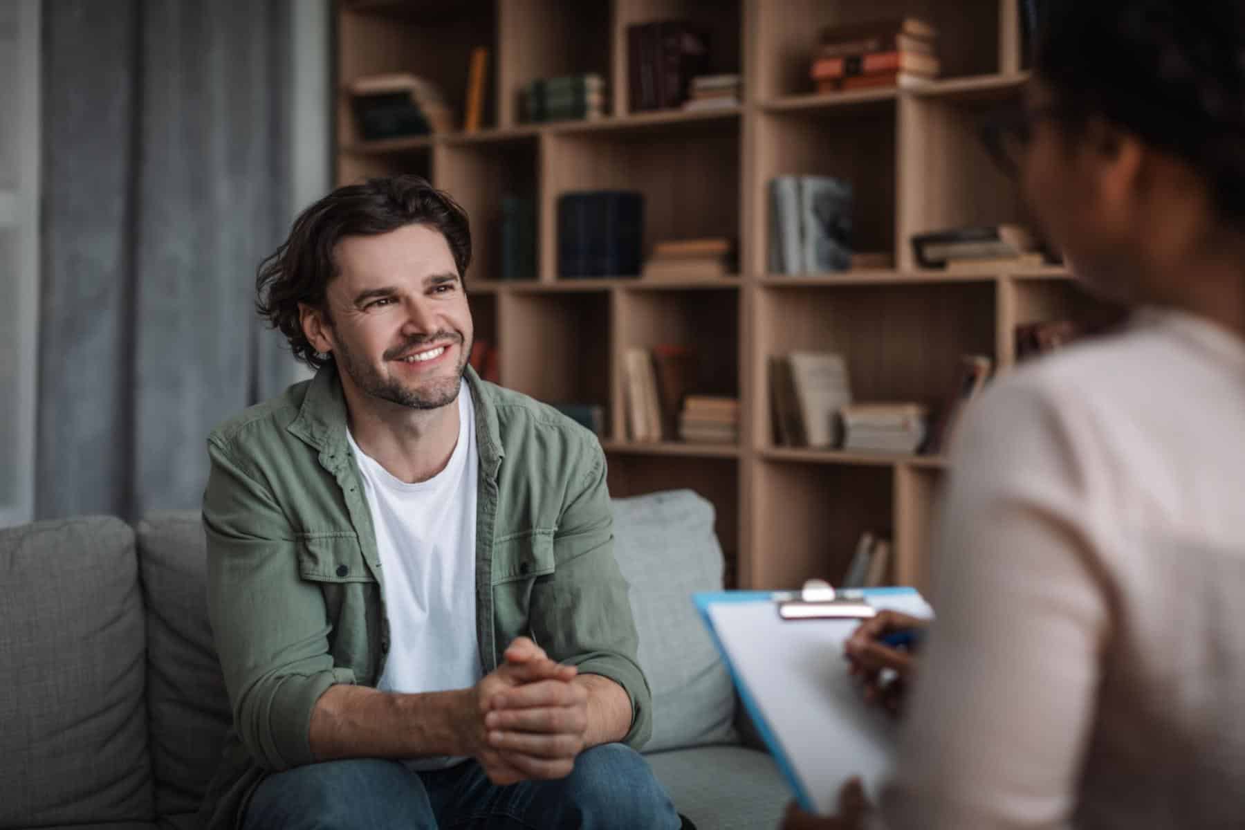 a man and woman sitting on a couch in a living room