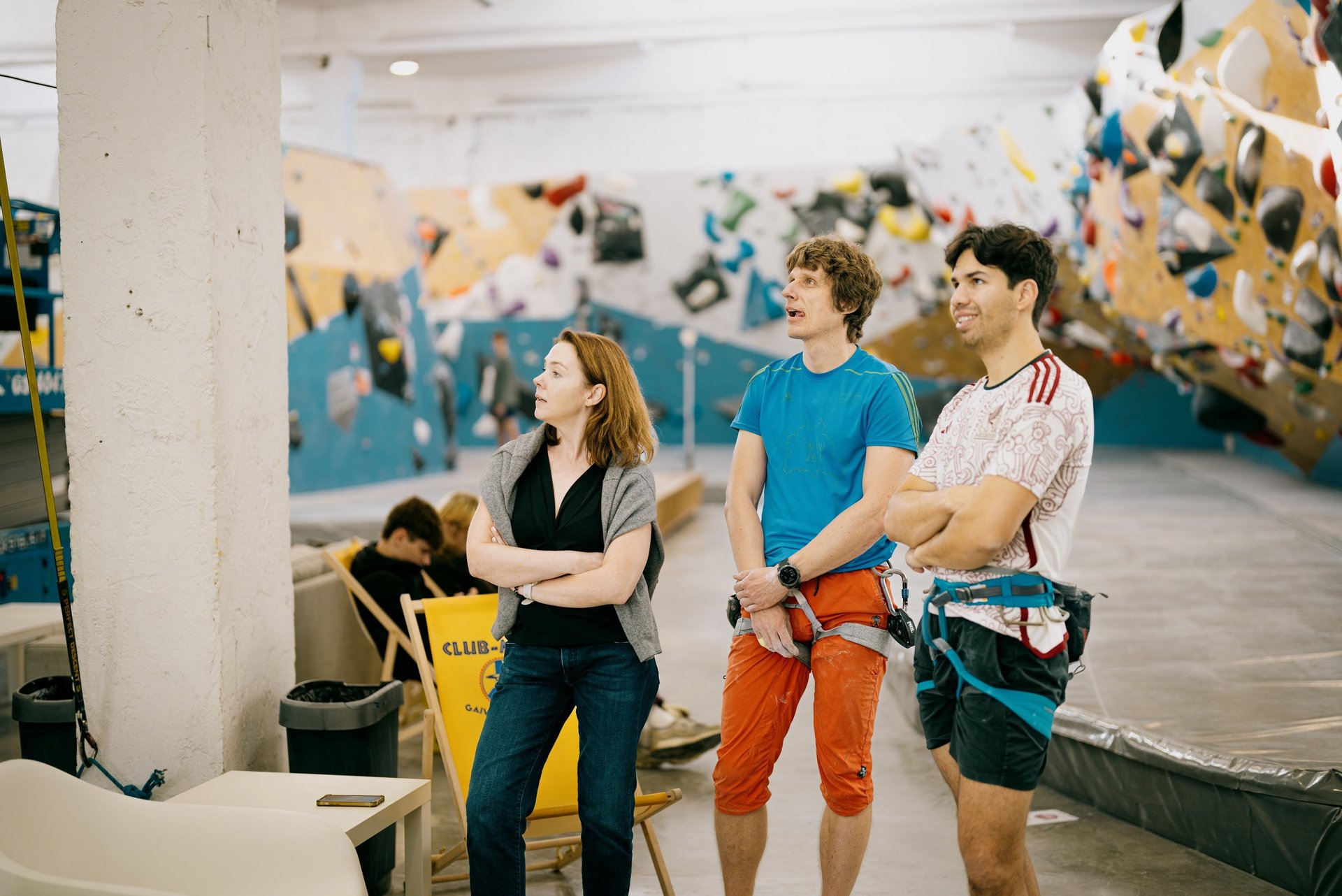 a group of people standing in climbing wall