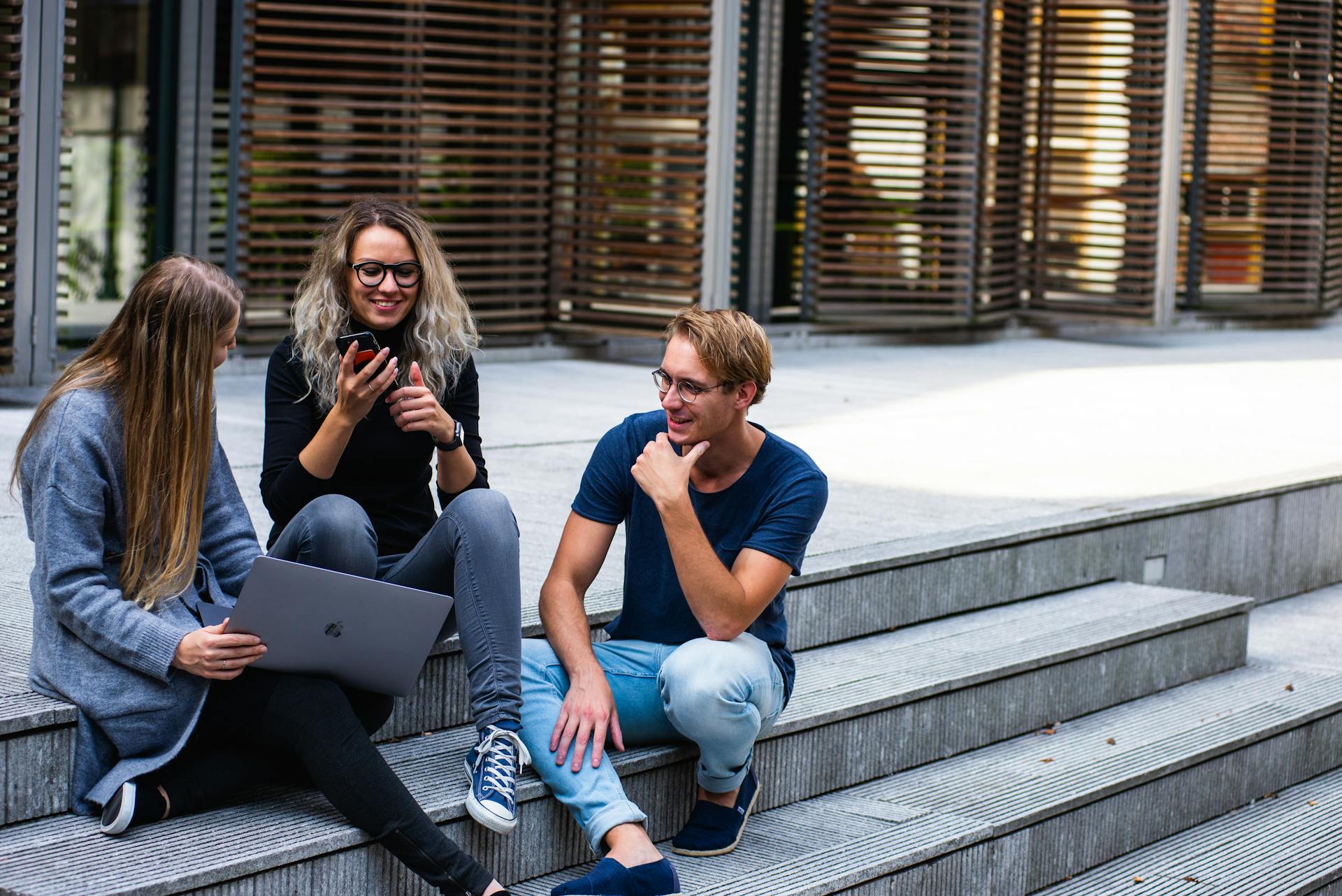 group of young millennials chatting in group on stairs representing gold ira for millennials