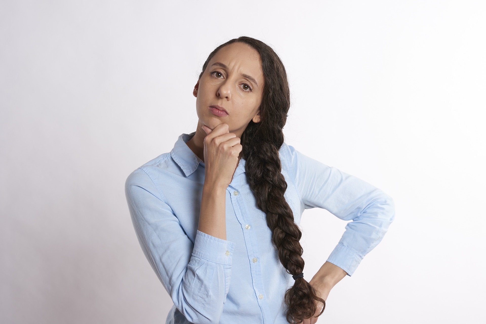 woman thinking thoroughly and wondering if gold ira is a scam