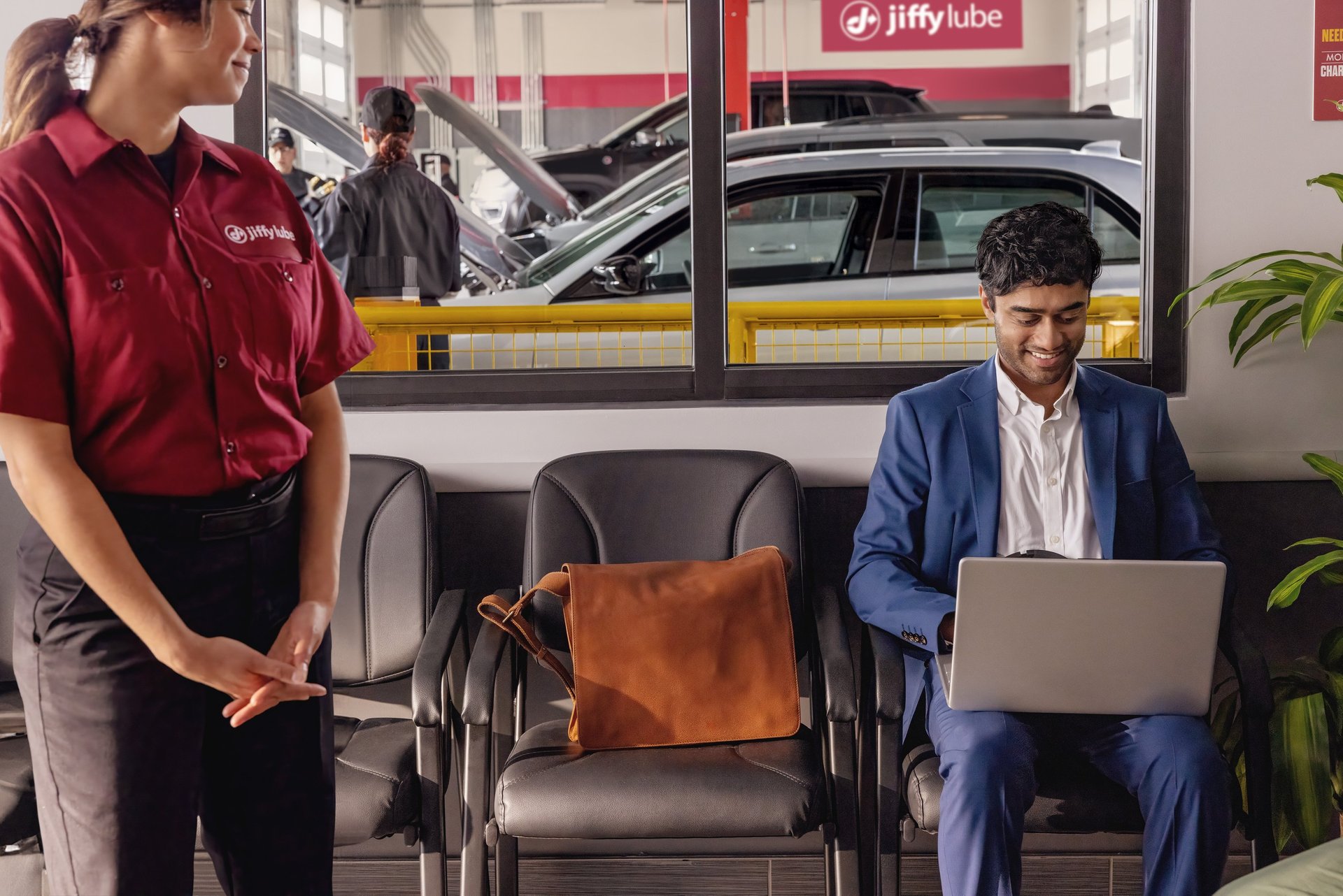 Jiffy Lube employee standing and observing the service area.