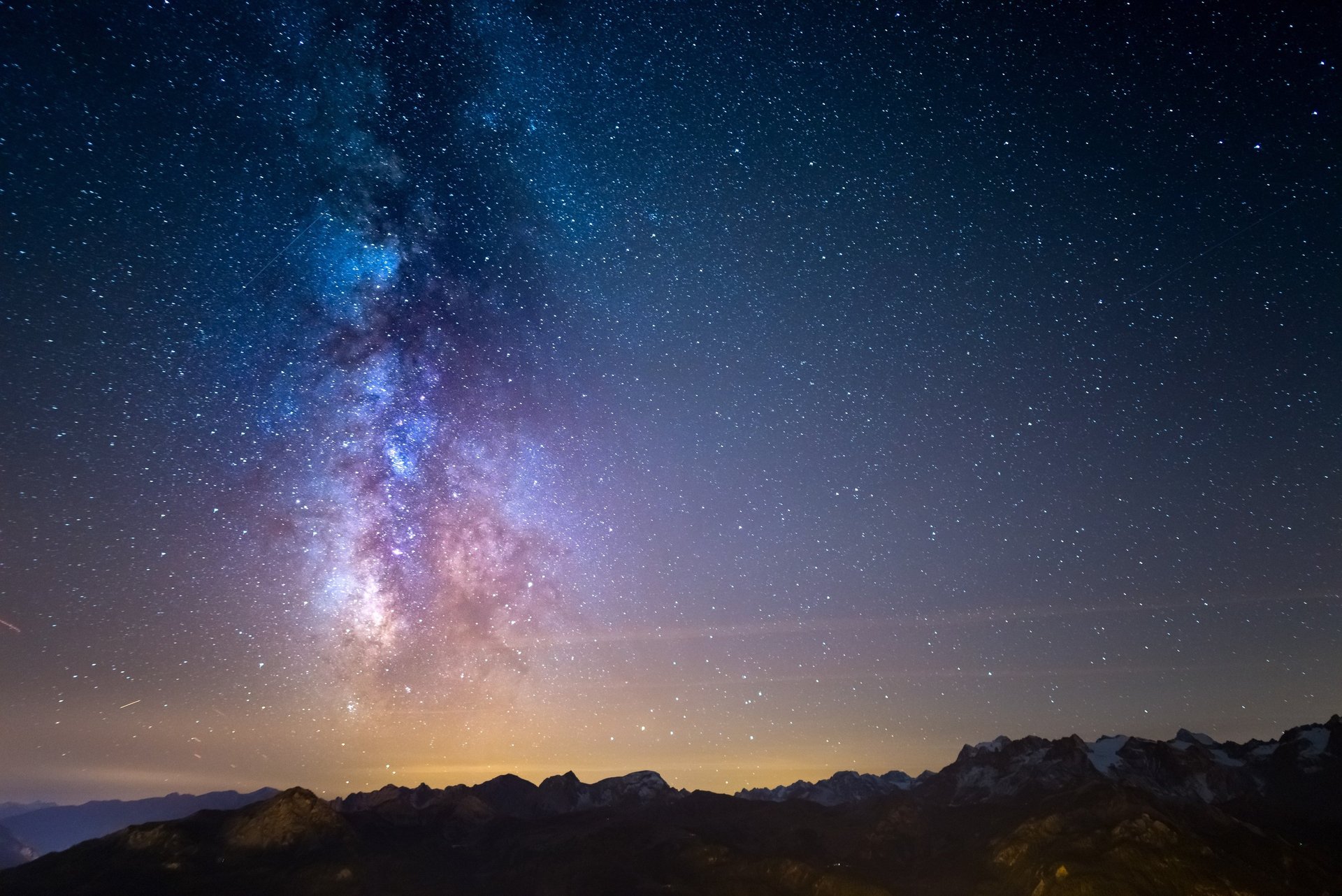 Milky Way galaxy over snowy mountains