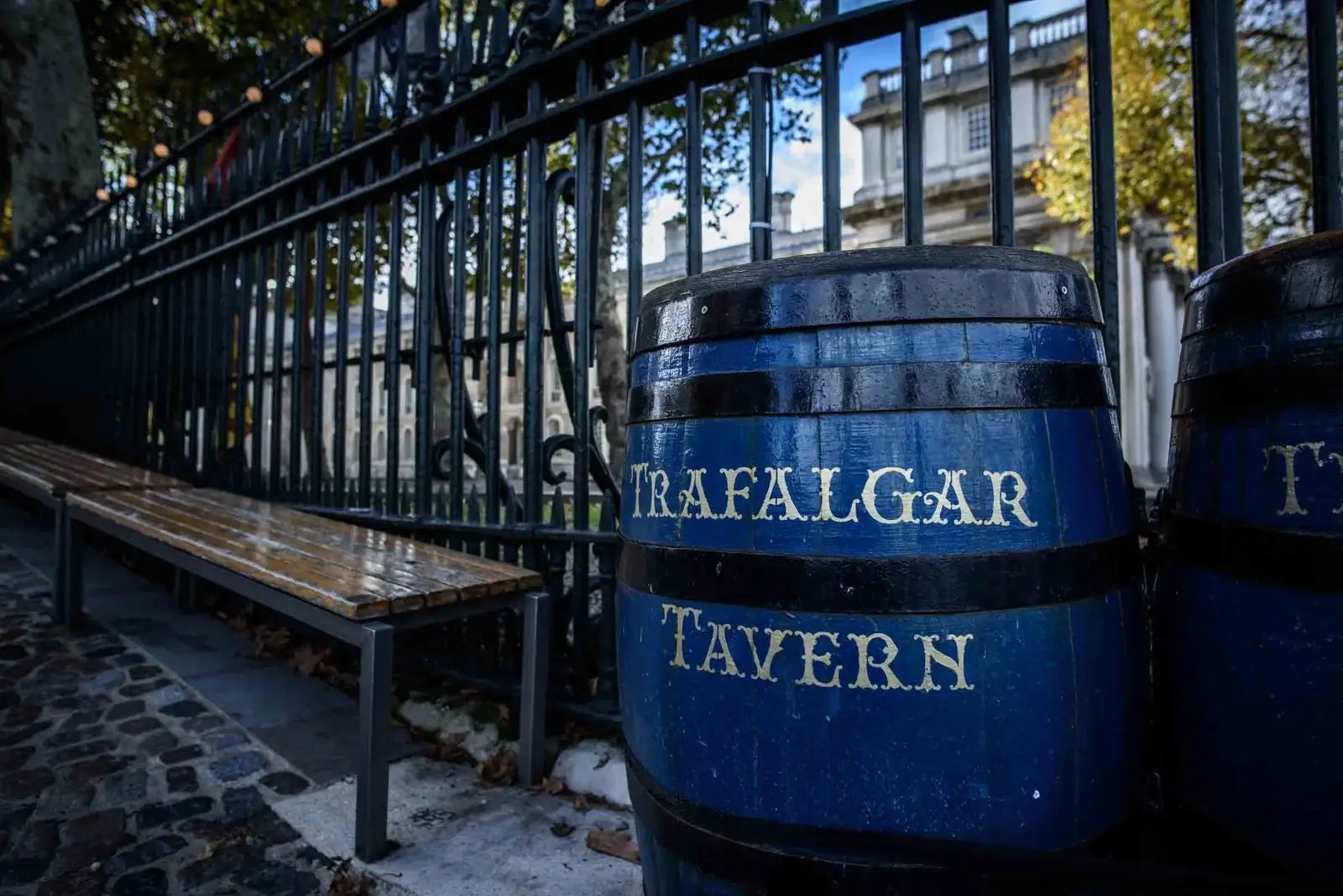 Blue painted barrel with Trafalgar Tavern sign outside a historic London pub in Greenwich.