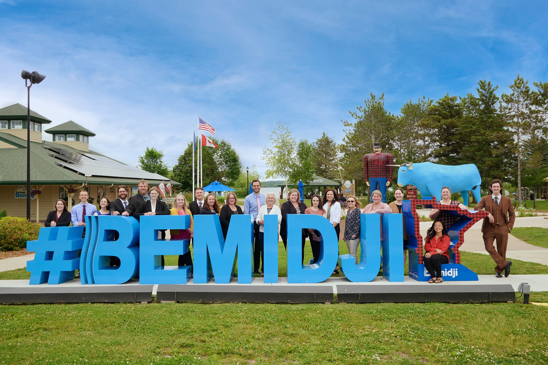 a group of people standing in front of a sign that says bemidji