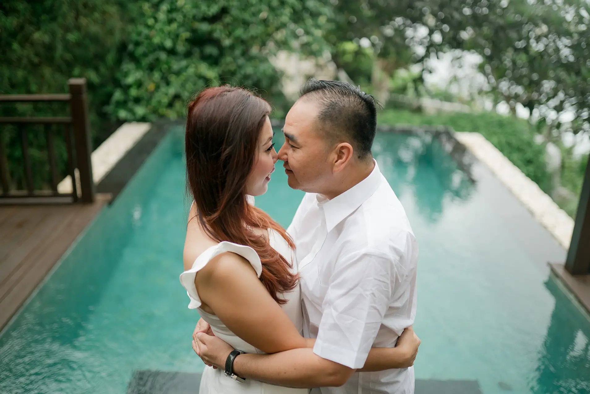 Selly couple embracing beside the pool at Karma Kandara Uluwatu Bali  