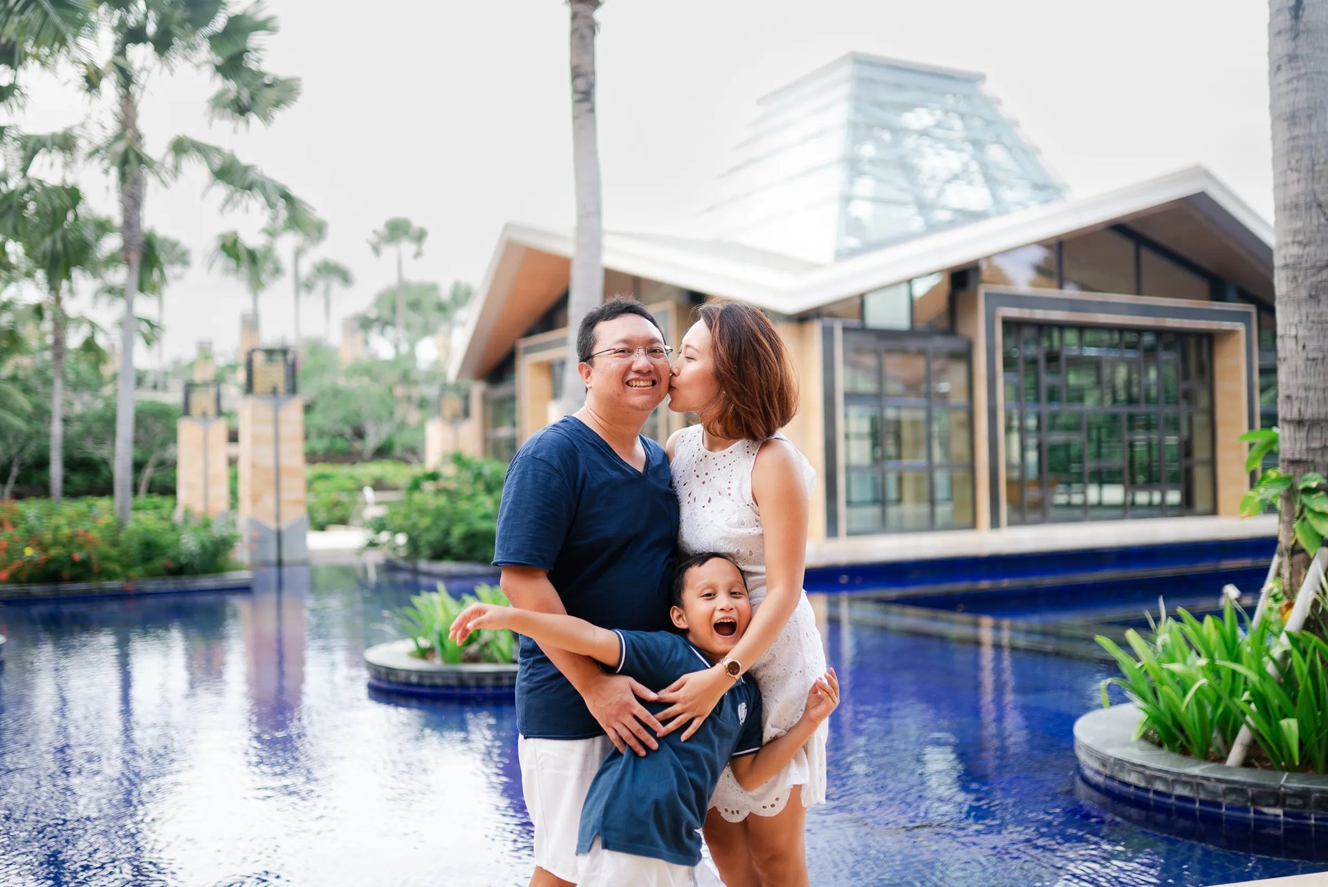 Family portrait beside reflecting pool at The Mulia Nusa Dua Bali