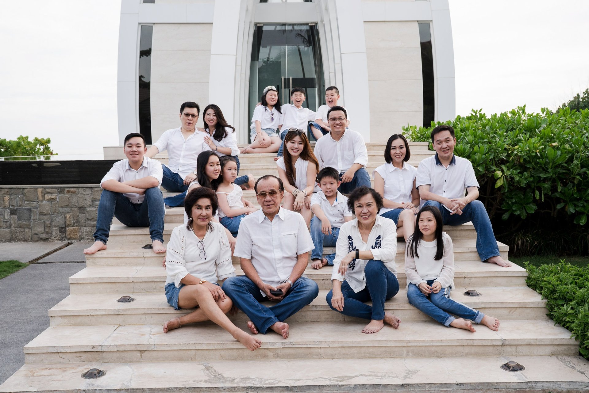 Large extended family portrait sitting together at The Ritz-Carlton Bali during a family photography session