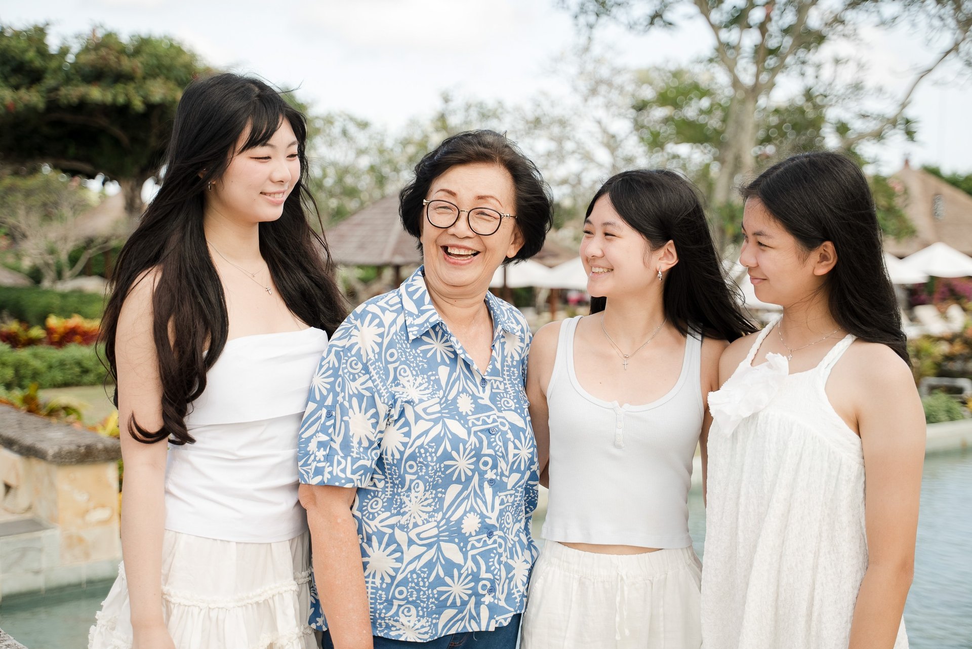 Grandma sharing a joyful moment with her daughters during a lifestyle family session at Ayana Resort Jimbaran Bali