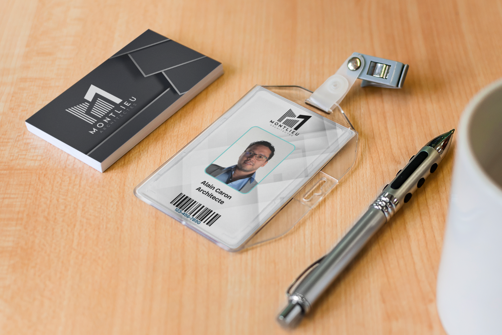 Professional architect employee identification badge and business cards on an office desk with a silver pen.