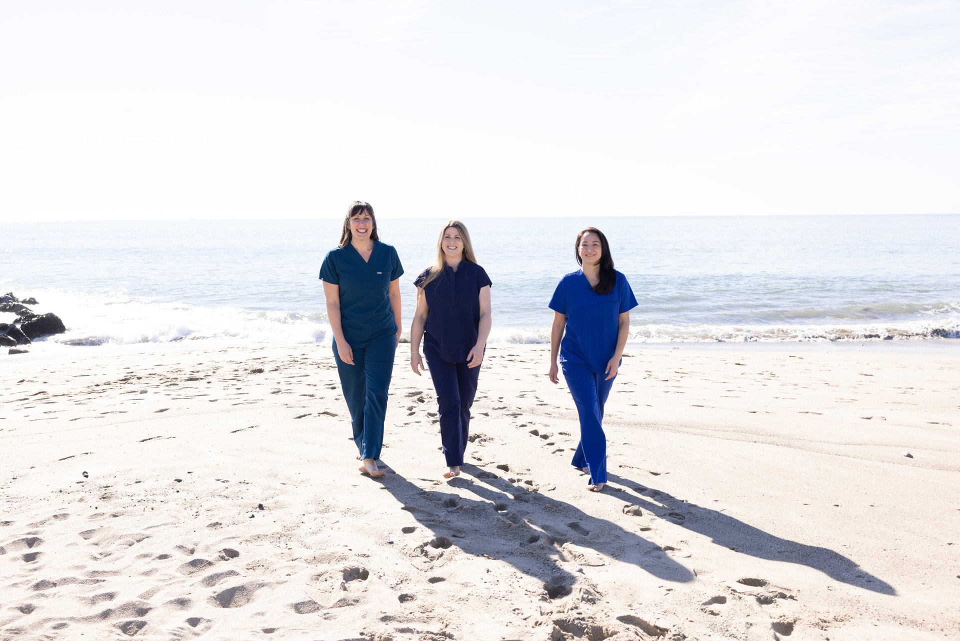 Our three doctors walking on the beach.