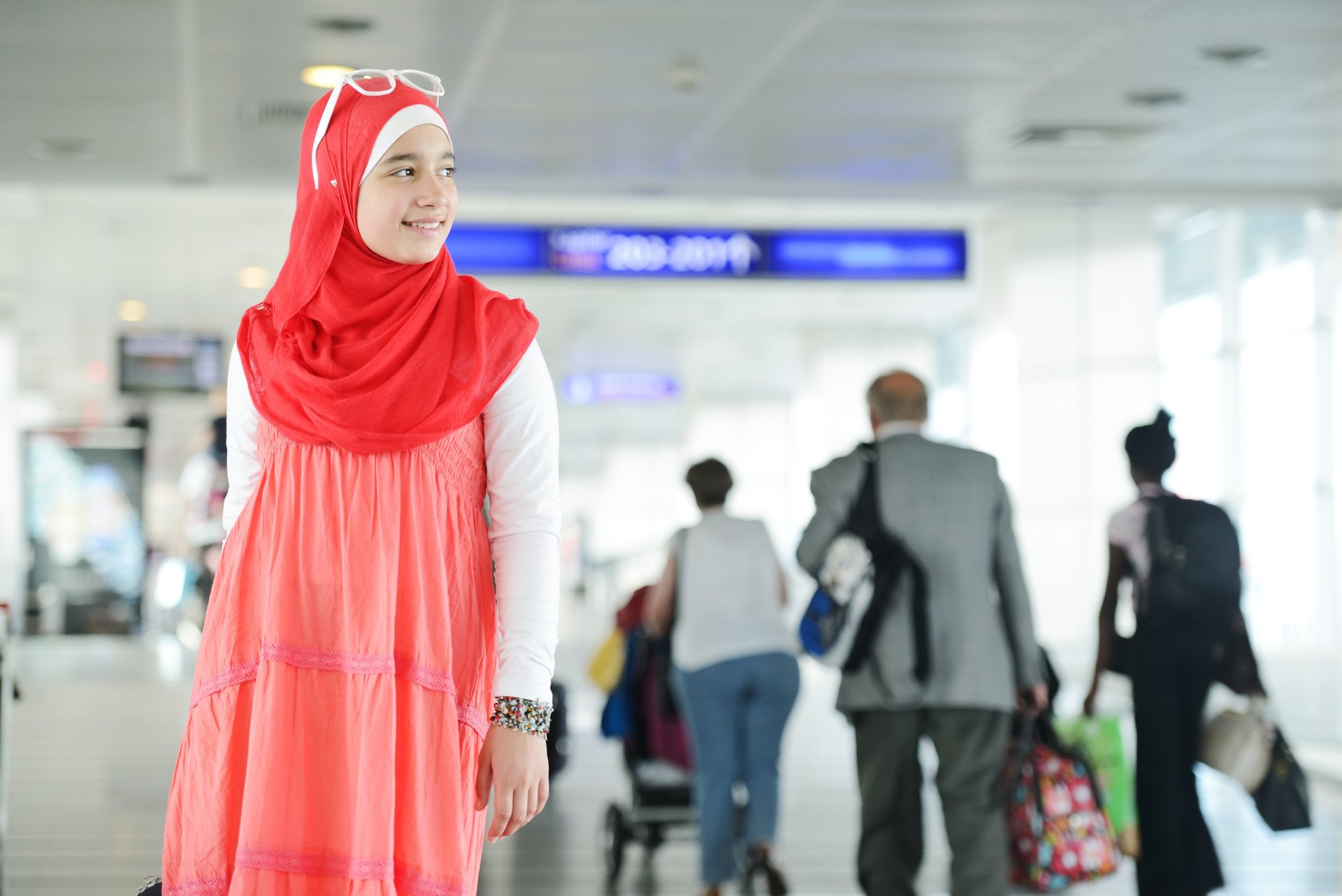 a woman in a red dress and a man in a suit for boarding 