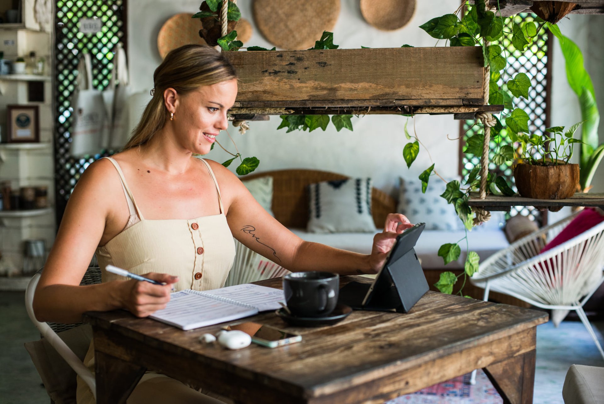 Woman working in a videocall boho living room with an ipad