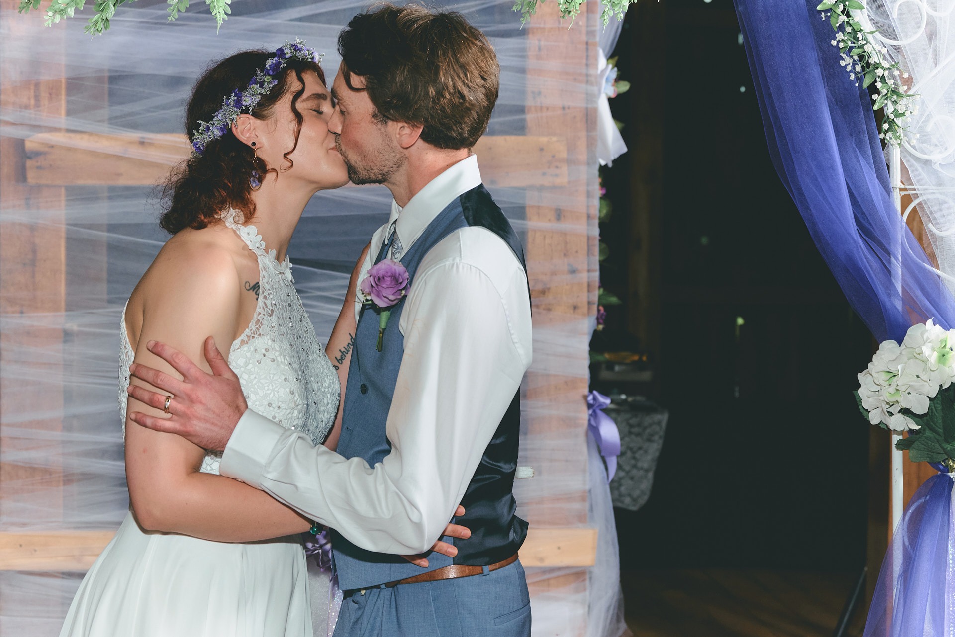 a bride and groom kissing in a wedding ceremony