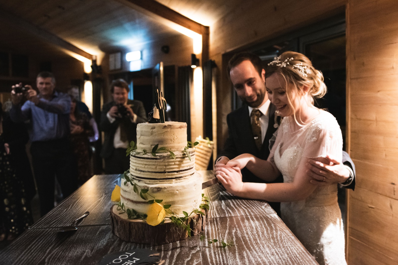 a bride and groom cutting their wedding cake