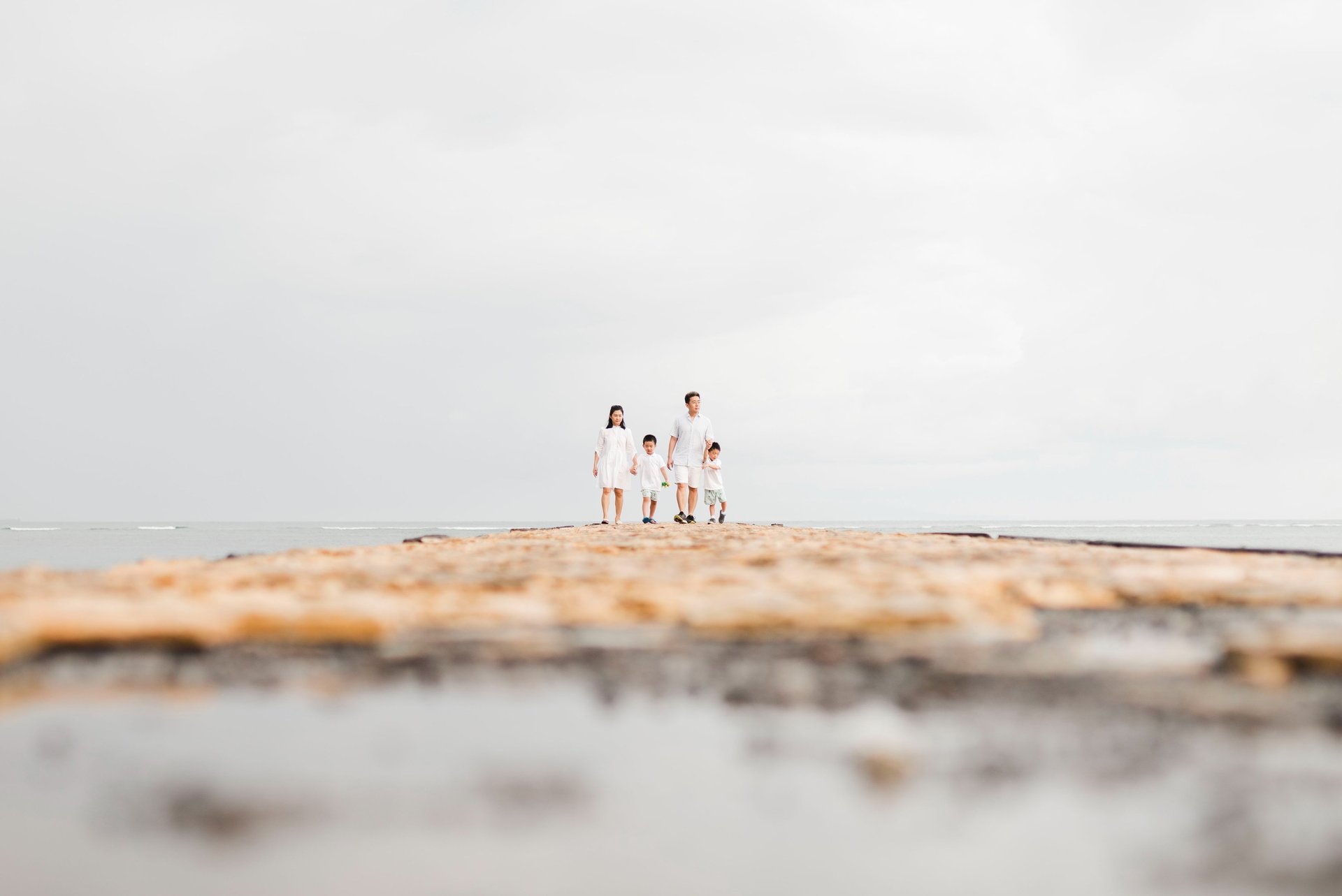 luxury family photographer in Bali capturing a quiet coastal moment at Conrad Bali