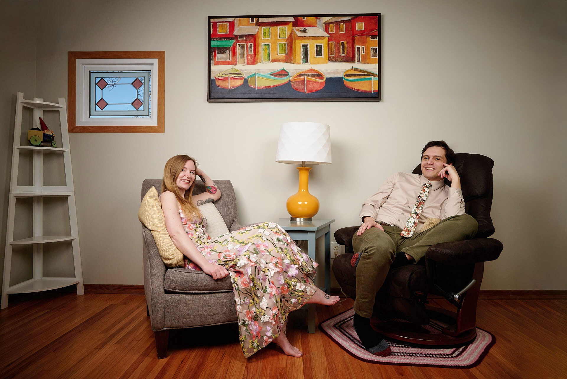 a man and woman sitting in a chair relaxing in the living room