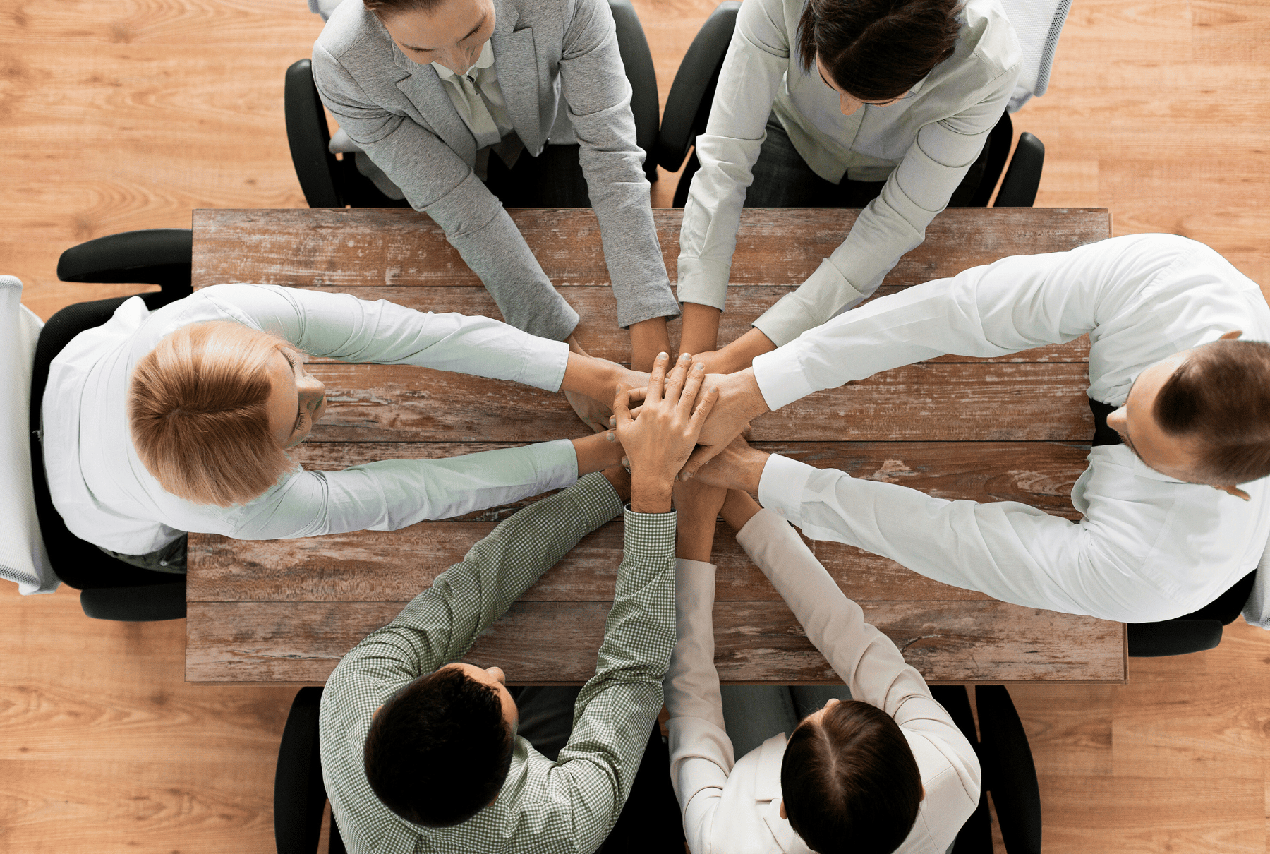 a group of business people sitting around a table