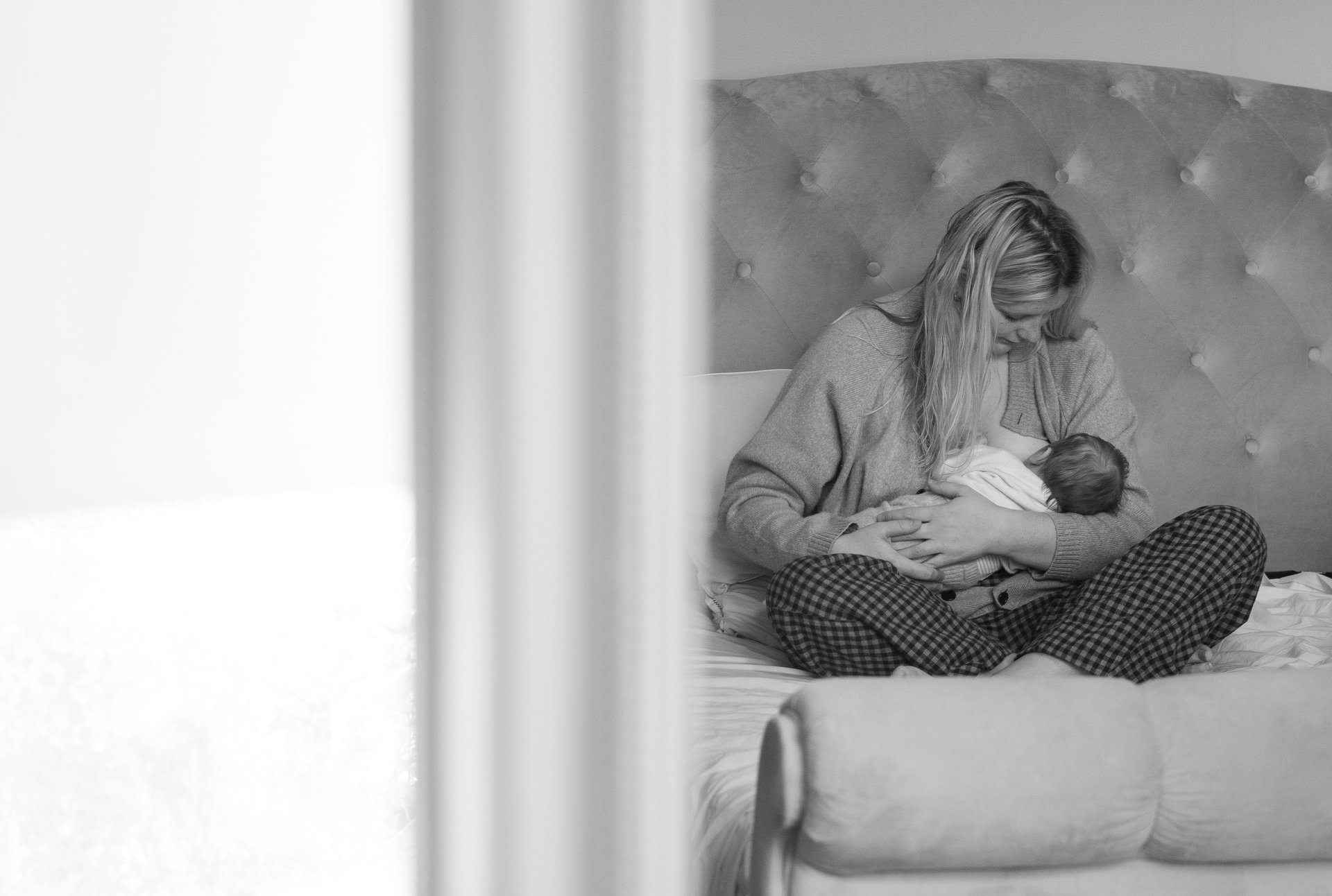 Mother holding her baby during an indoor photoshoot in Brighton.