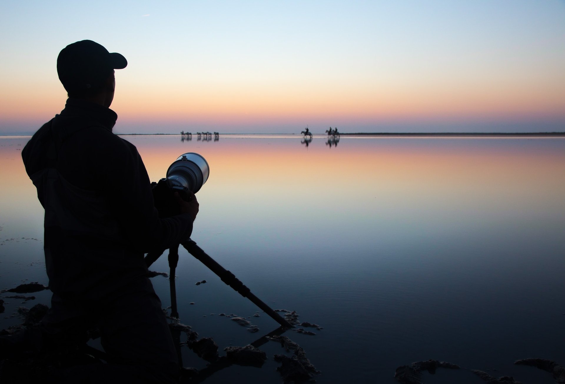 a photographer with a hat and holding a camera
