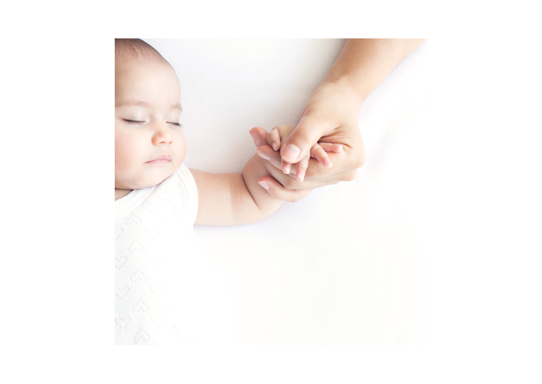 Mother holding sleeping baby's hand
