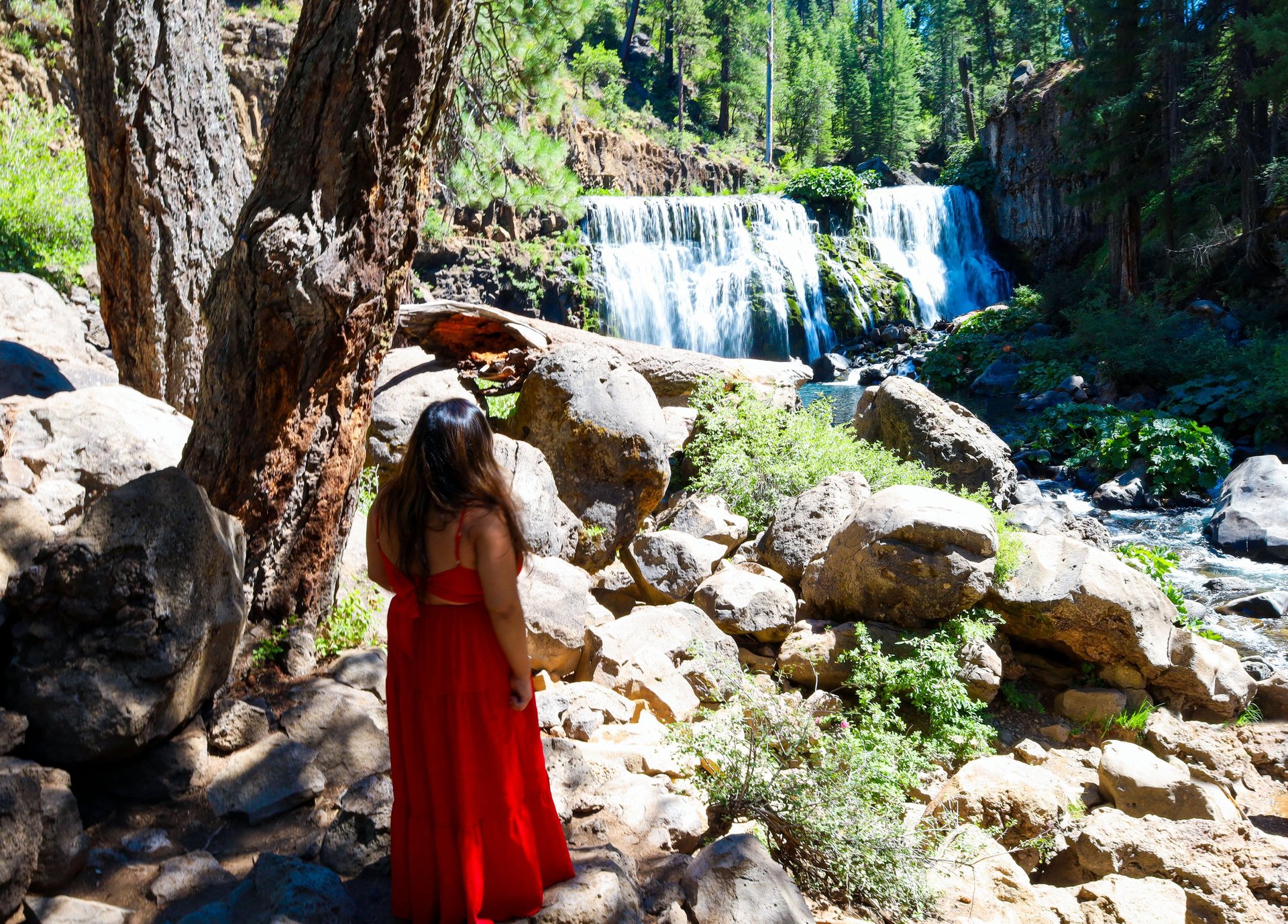 california, waterfalls, mccloud falls, a woman in a red dress standing in front of a waterfall