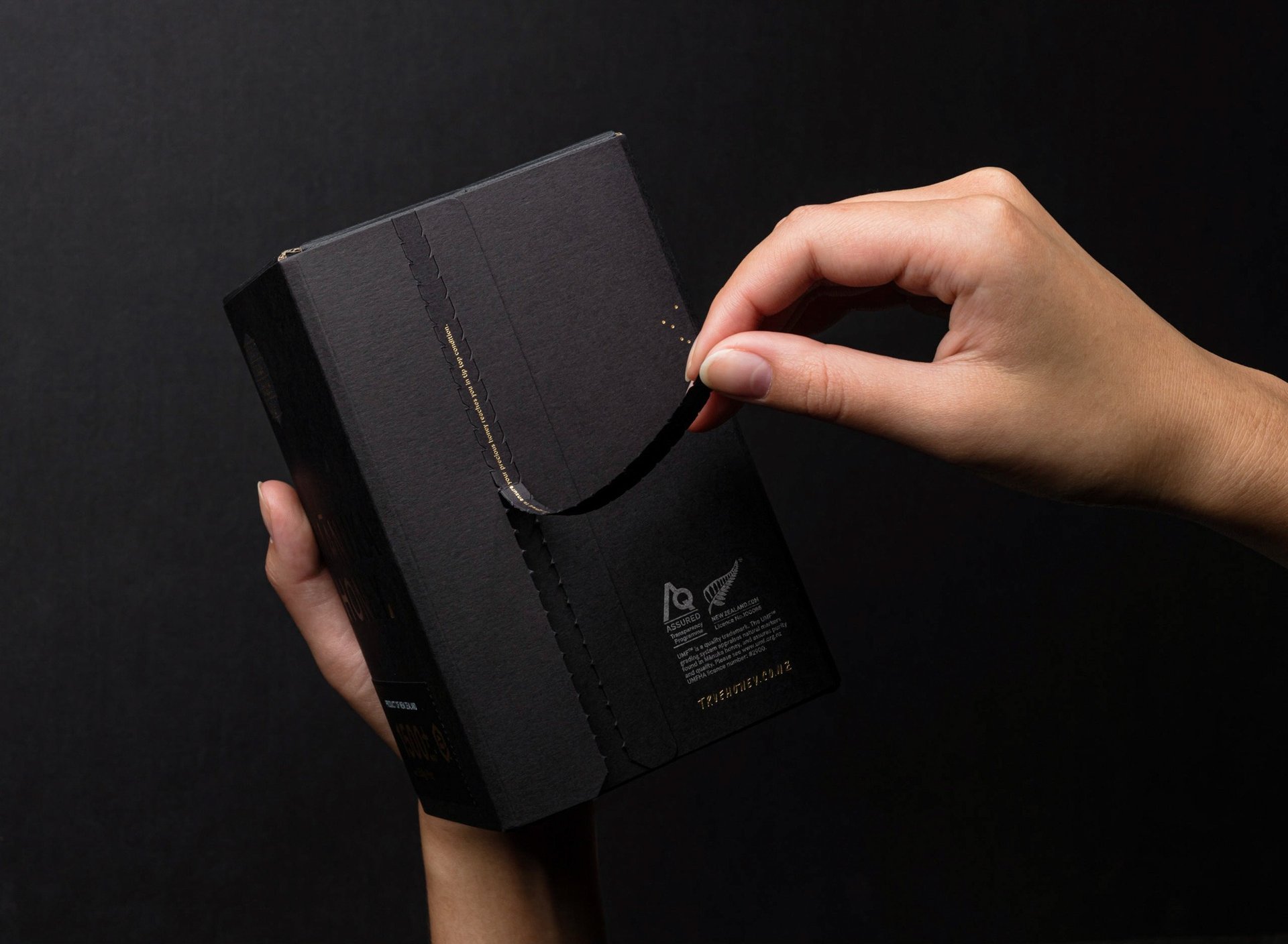 Product photography - a person holding a black box of honey