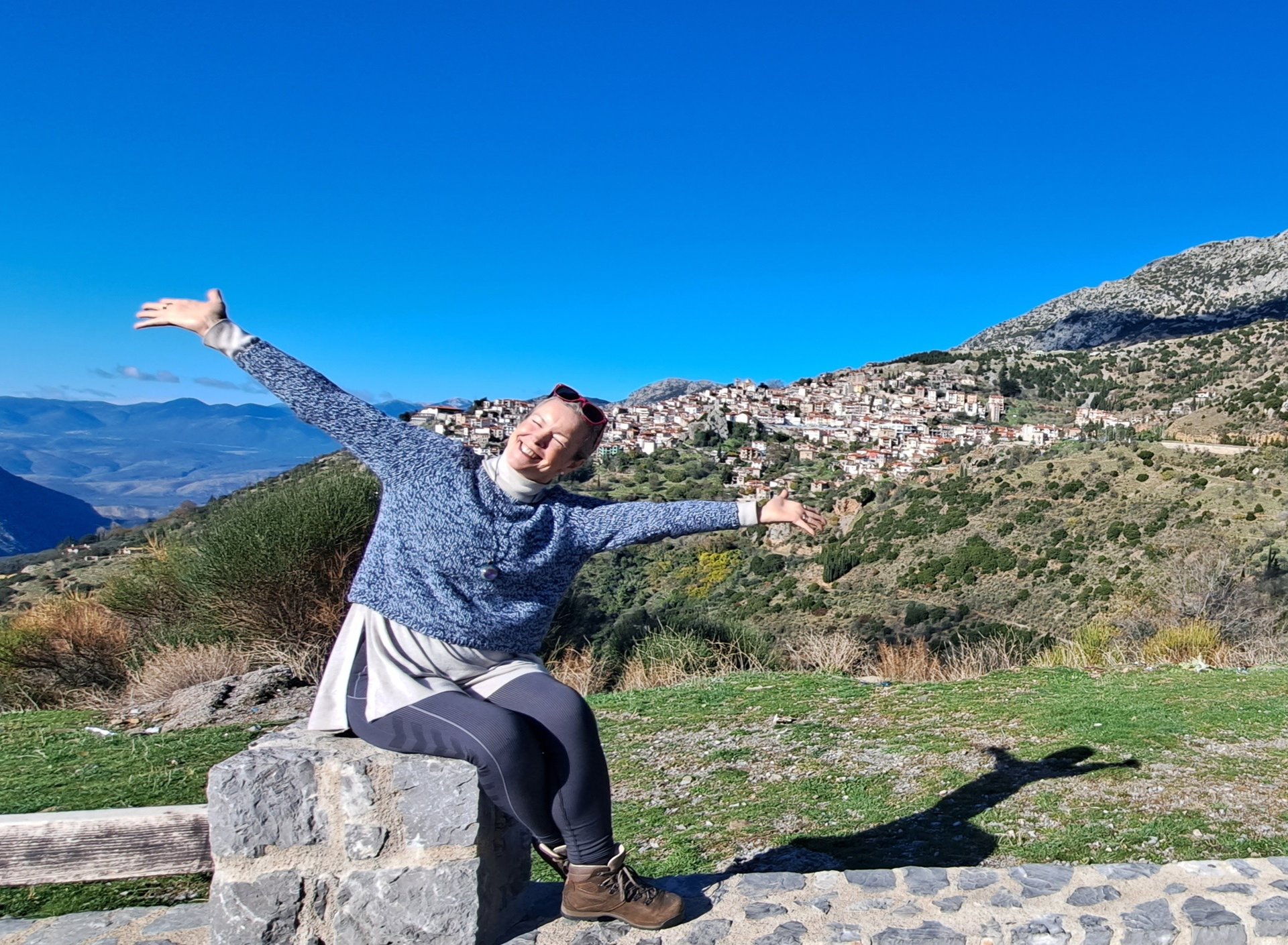 happy woman sitting in mountains