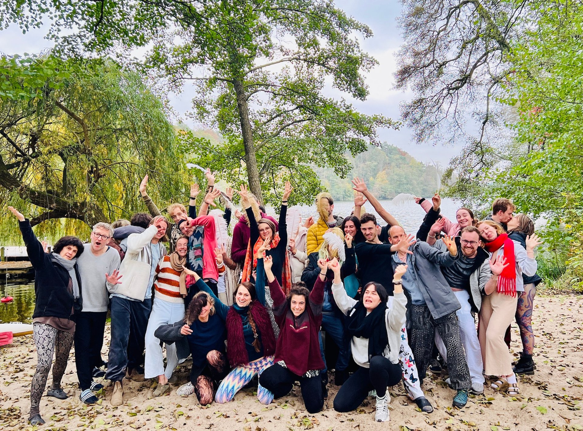 a group of people standing around a lake
