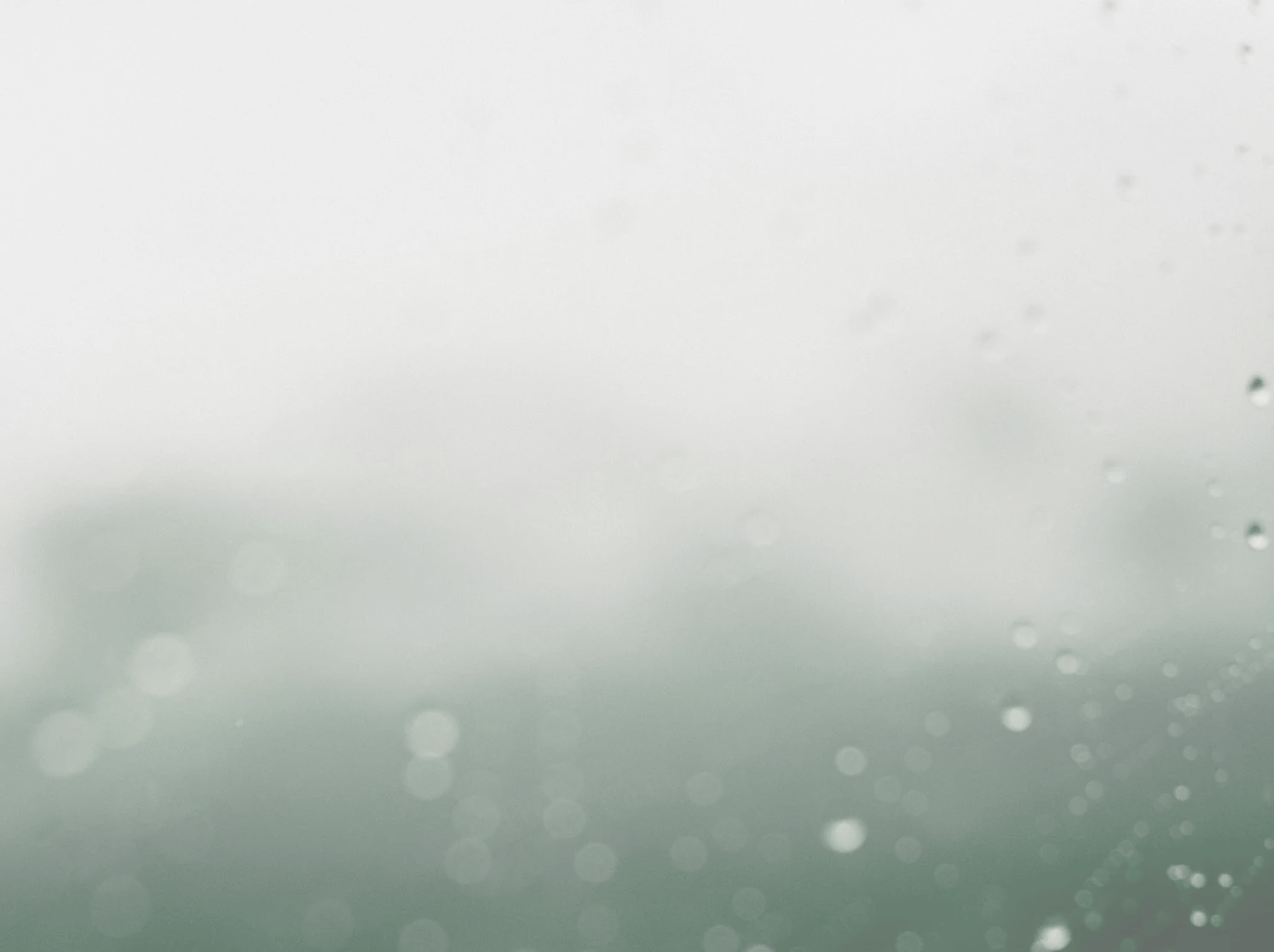 Abstract misty gradient from soft green to white, with delicate out-of-focus water spots.