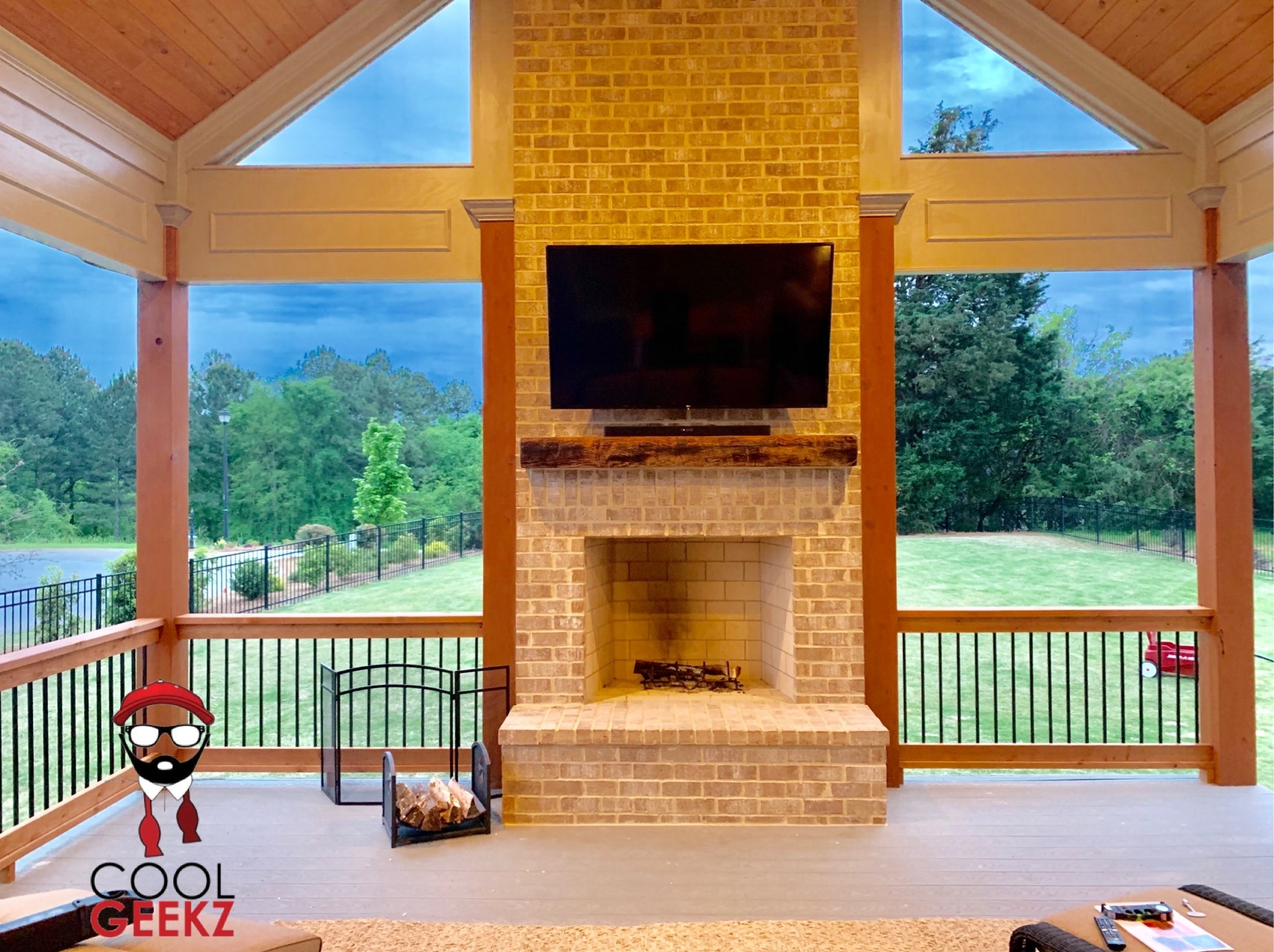 outdoor tv and soundbar mounted on a brick fireplace