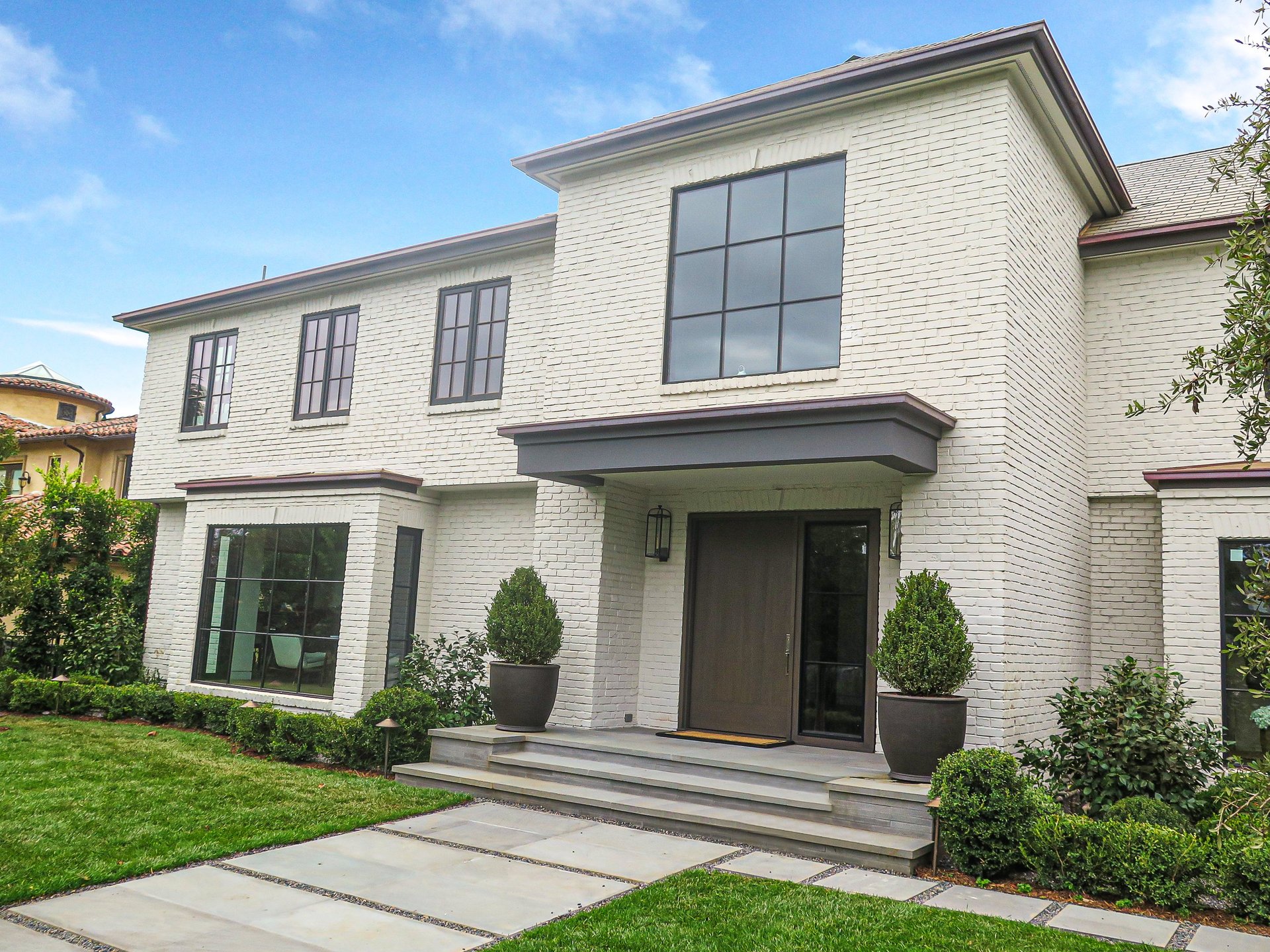 a white house with a large front door and a large front door