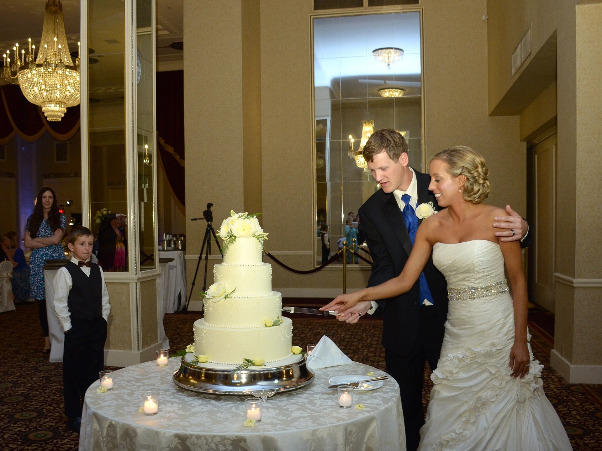 a bride and groom cutting their wedding cake in a hotel