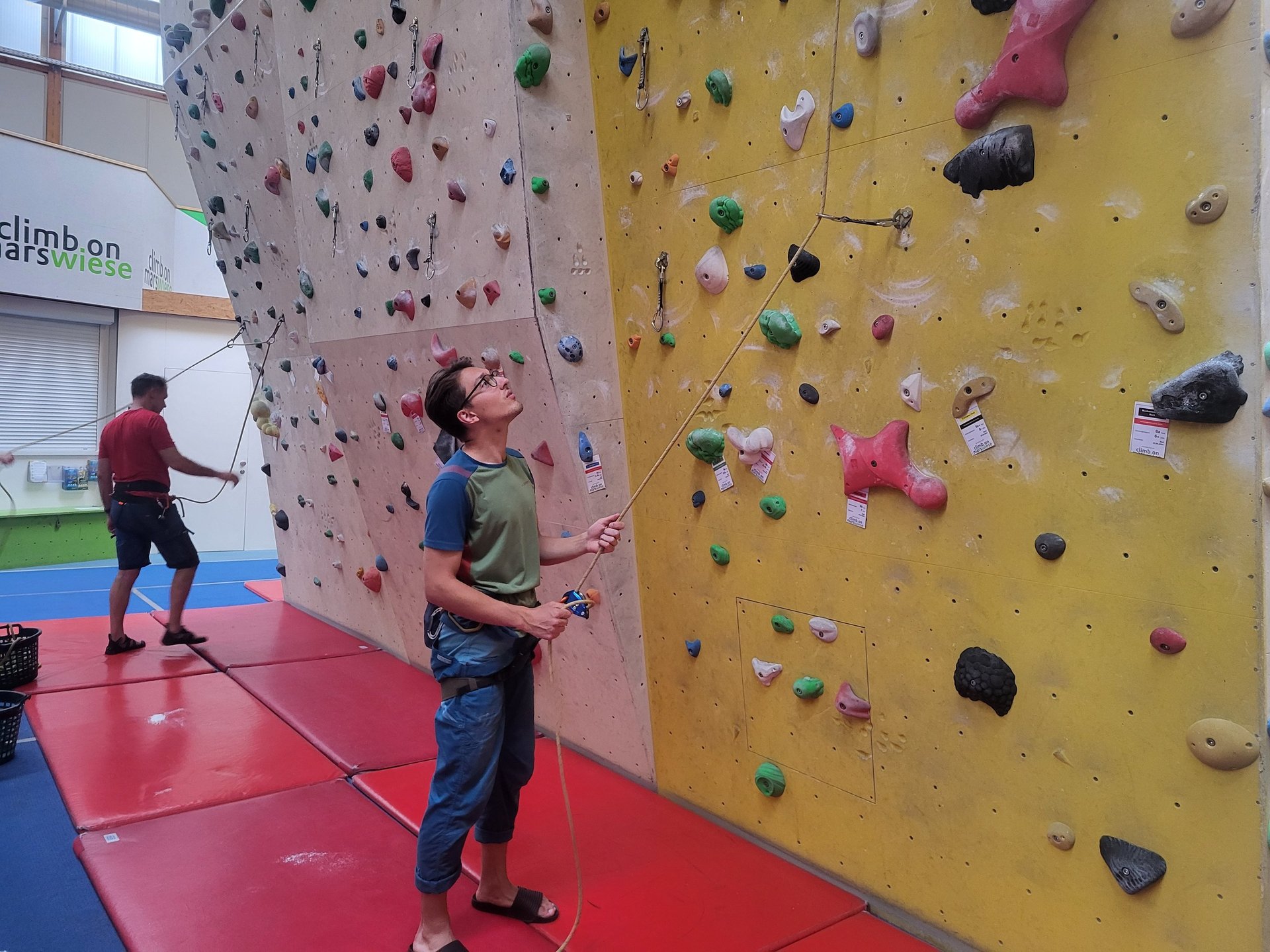 Participant belaying their partner in a lead climbing course in Vienna