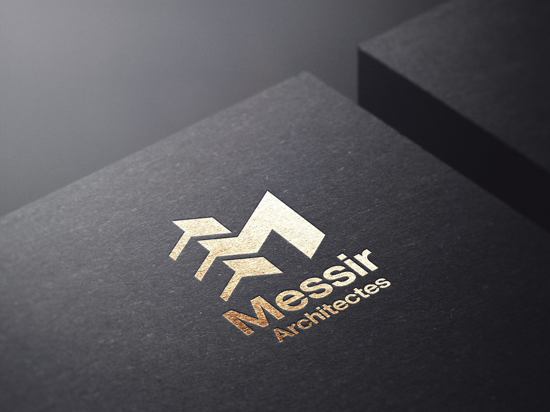 Elegant gold foil architects logo embossed on a textured black paper business card mockup.