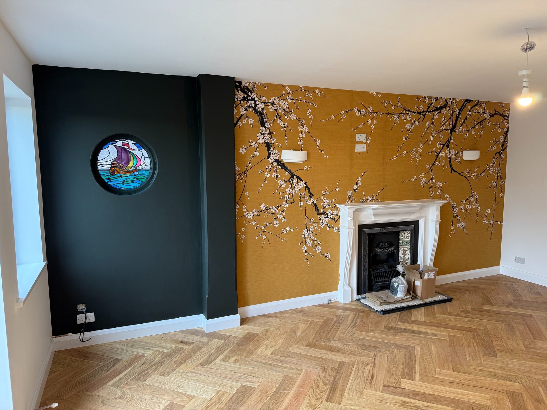 Wallpaper installation in a Brighton living room with fireplace