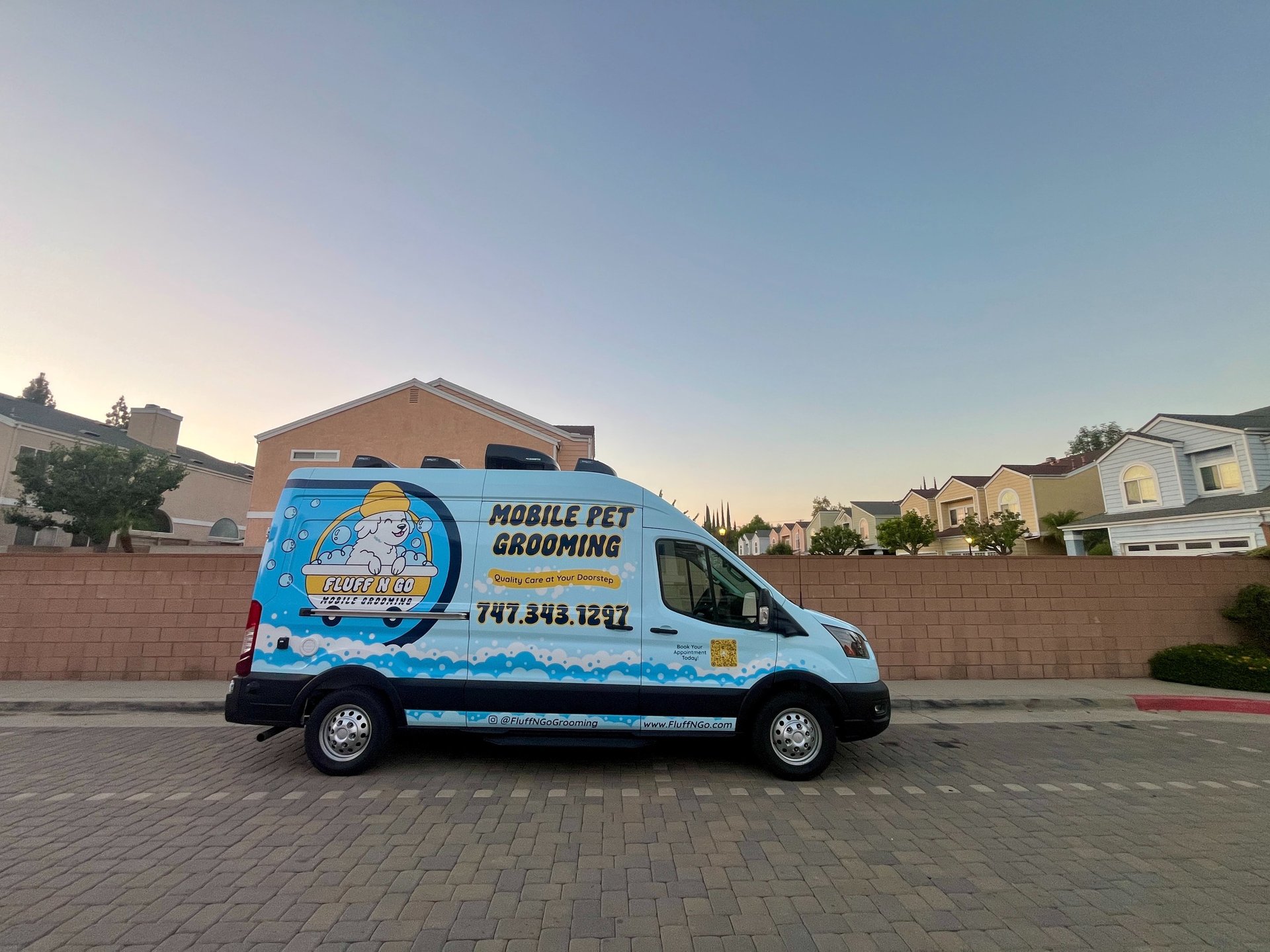 Fluff N Go mobile dog grooming van parked in a Los Angeles residential neighborhood