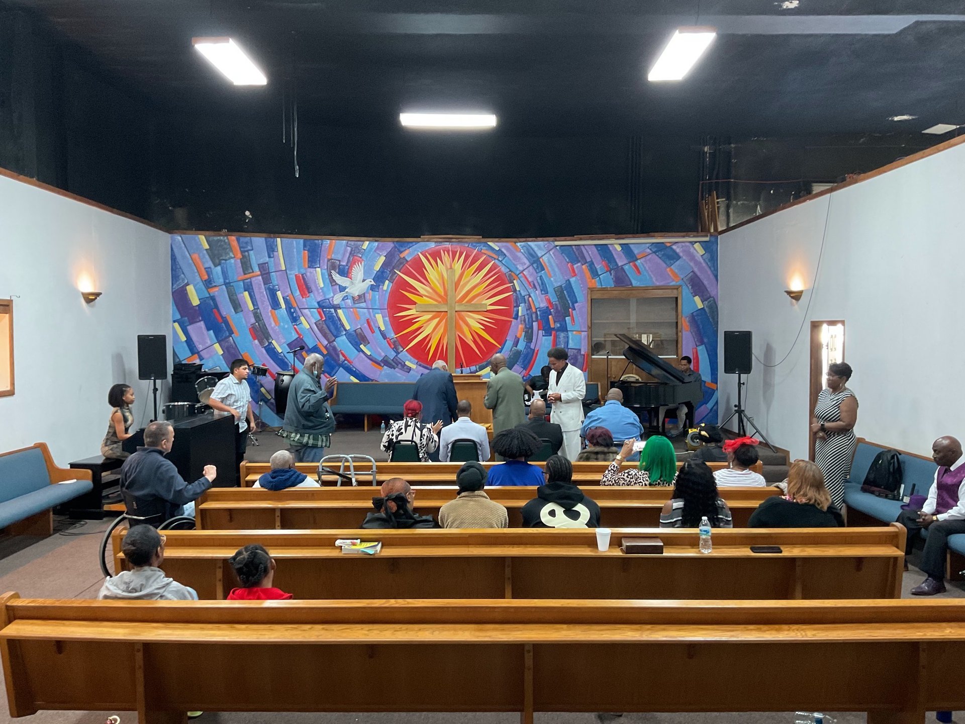 a group of people sitting in a church with a pulpit