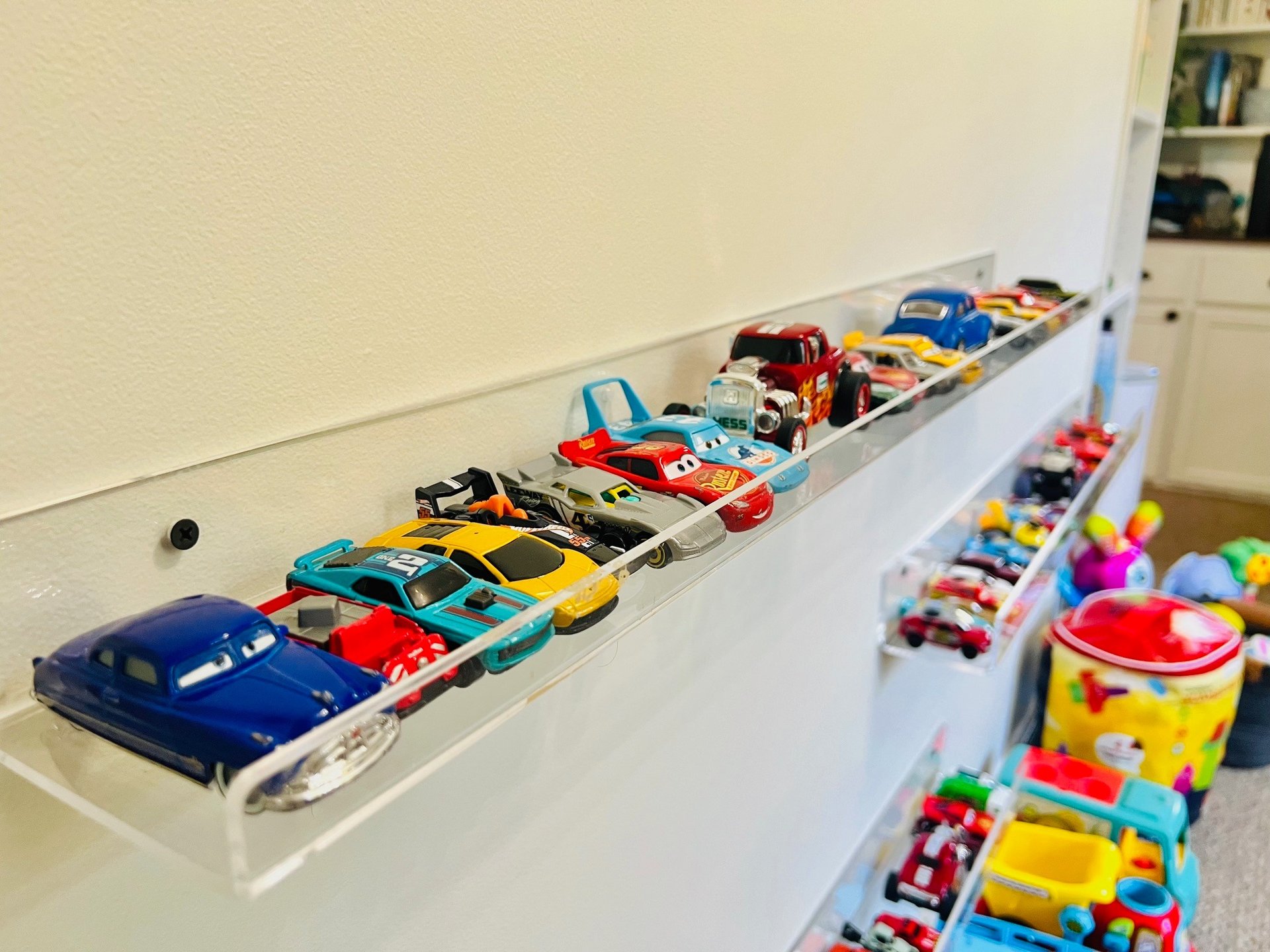 a collection of toy cars on display in a room