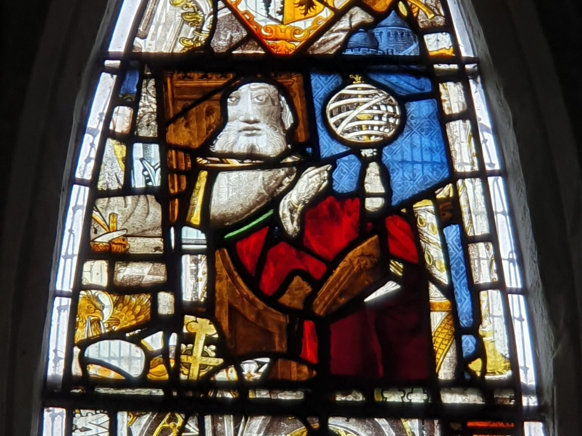 Detail of the East Window at All Saints Church, Landbeach. Figure of a magus with armillary sphere.