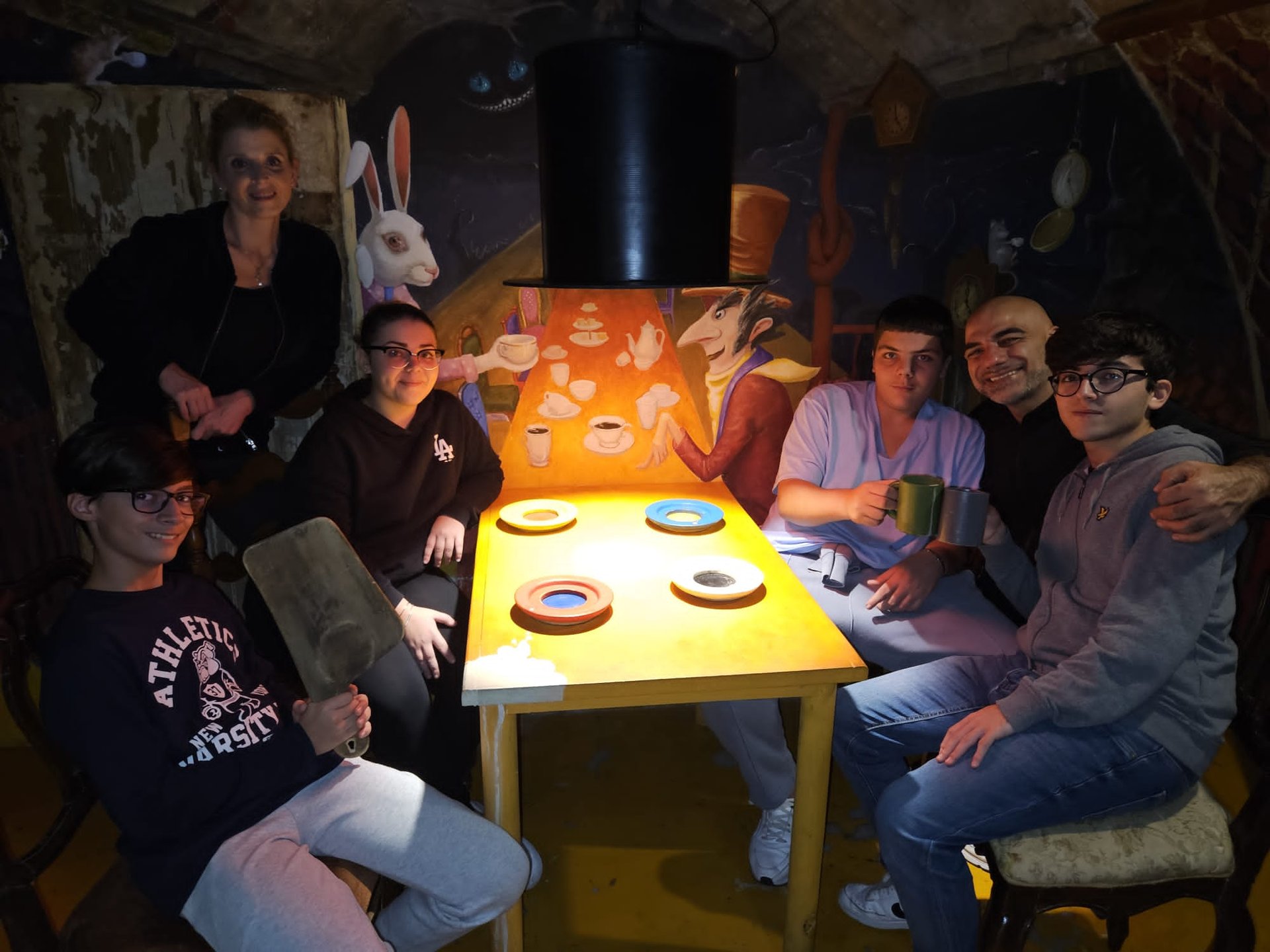 a group of people sitting around a table with a table with a table cloth