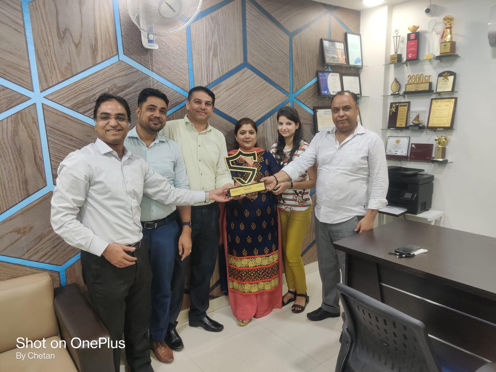 a group of people standing around a table