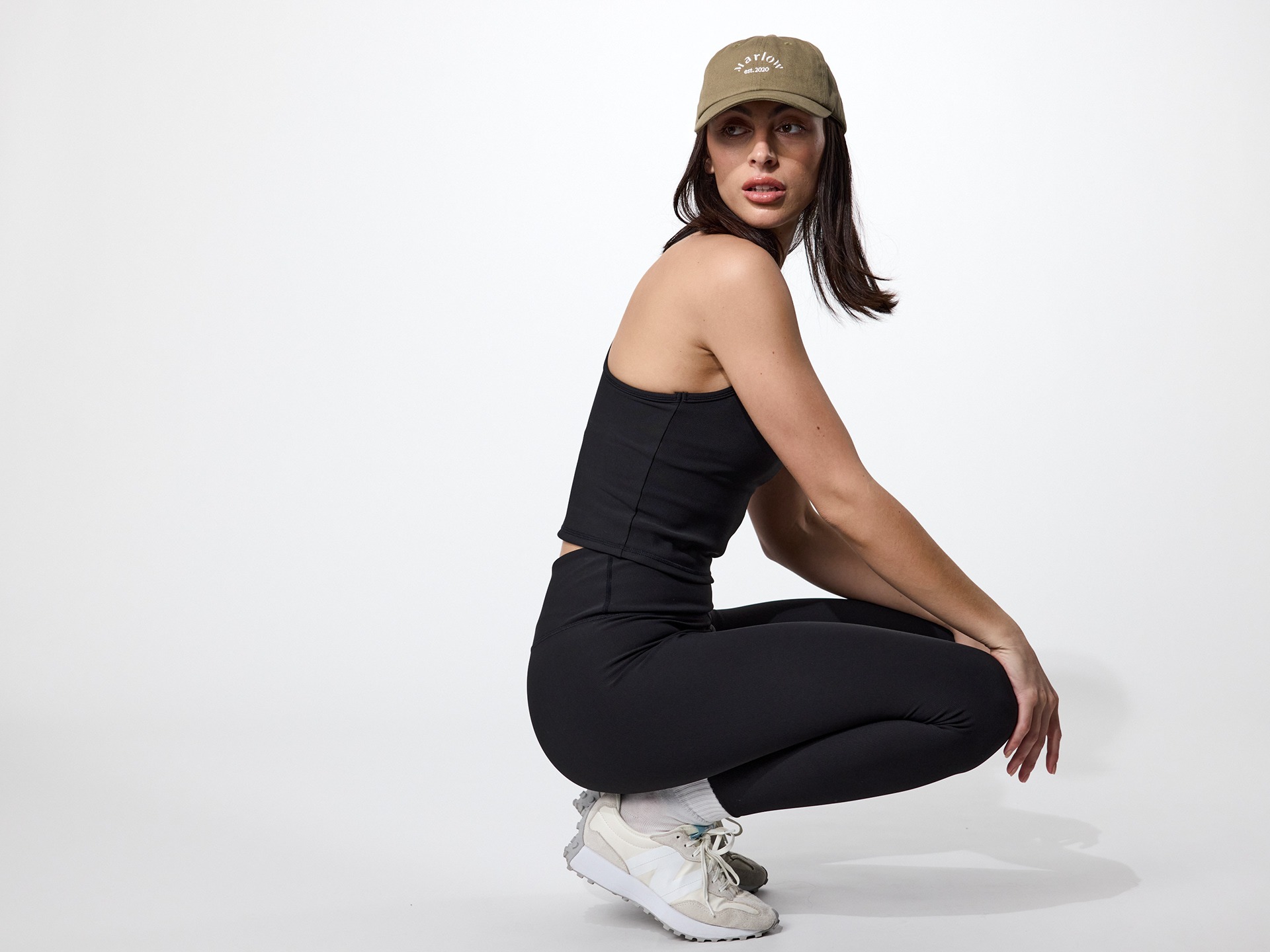 Fashion e-commerce photography - a woman in a black top and white sneakers